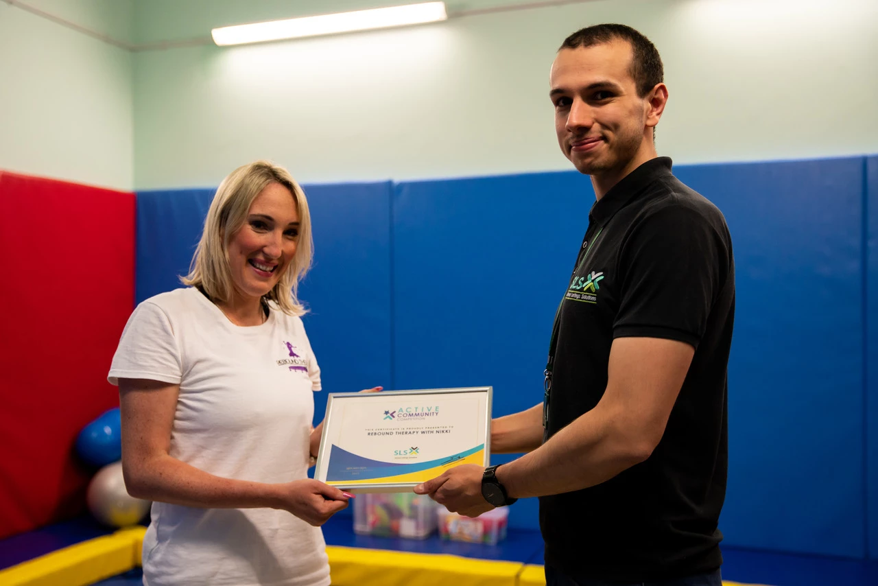 Nicola Breslin accepts Active Community award from Tom Hemsley at School Lettings Solutions