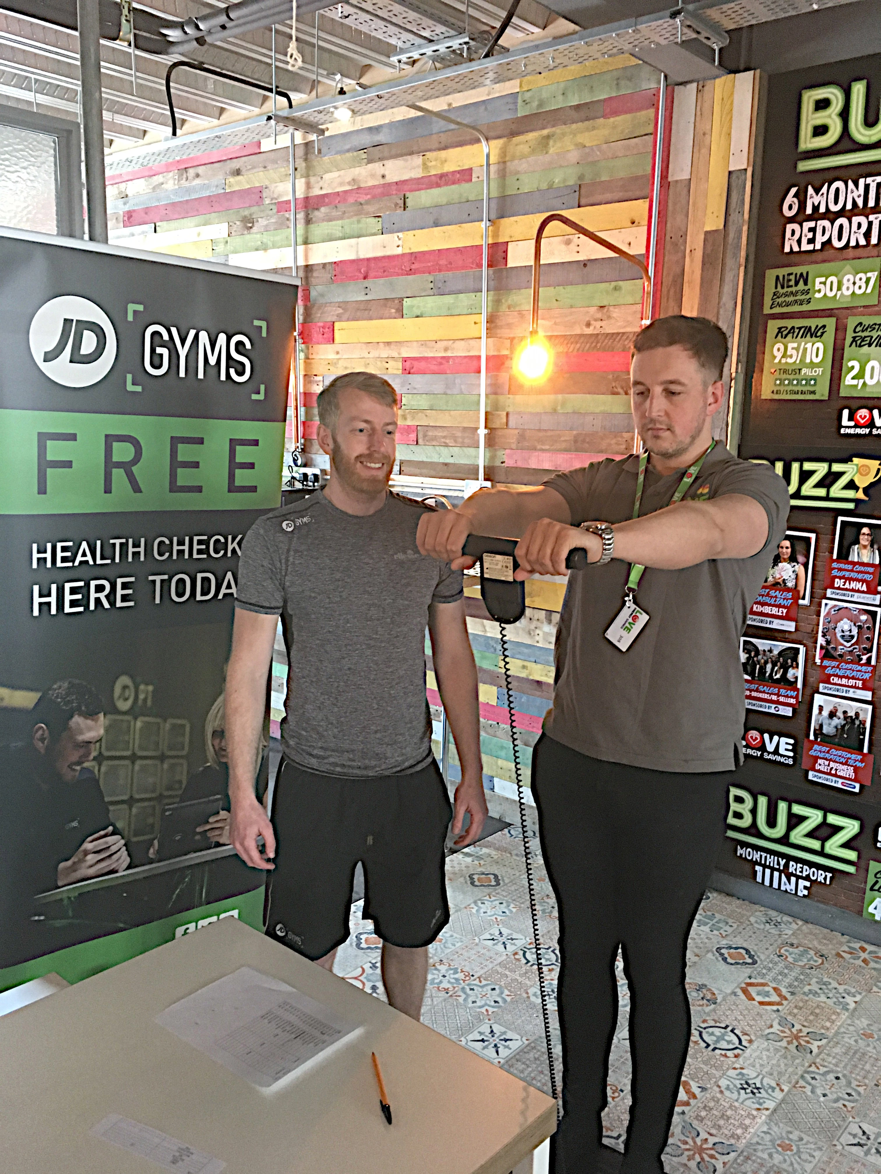 Love Energy Savings staff member Brian Foster is put through his paces by JD Gyms' staff