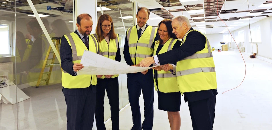 (L-R) Swinburne Maddison partners Jonathan Moreland, Carolyn Beal and Martyn Tennant study the plans for their office remodelling with Heather Baxter and Ian Moir from AMH Interiors