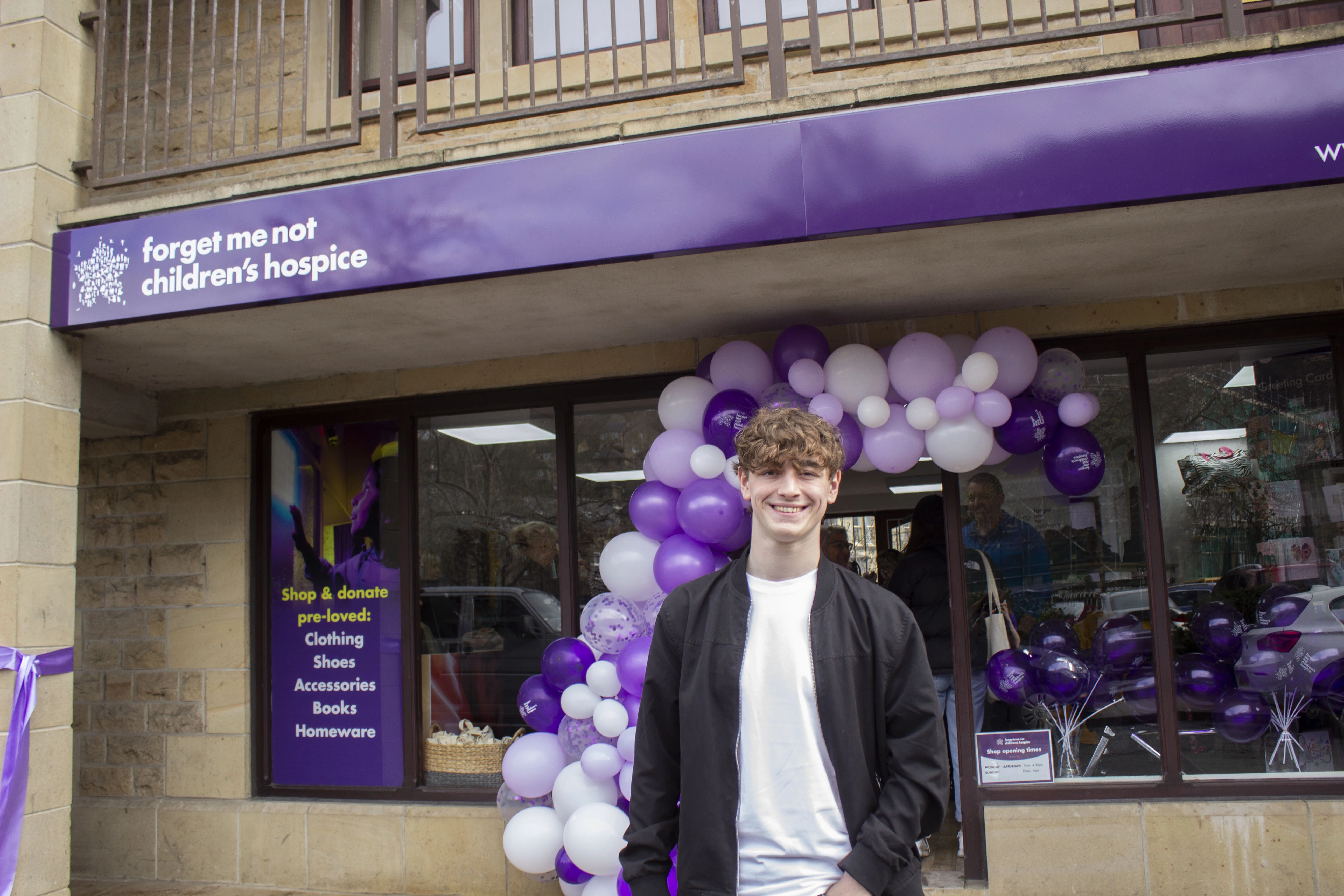 Happy valley star Rhys Connah in front of Forget Me Not charity shop in Hebden Bridge, signage by Leading Edge Signage and Graphics Ltd .  