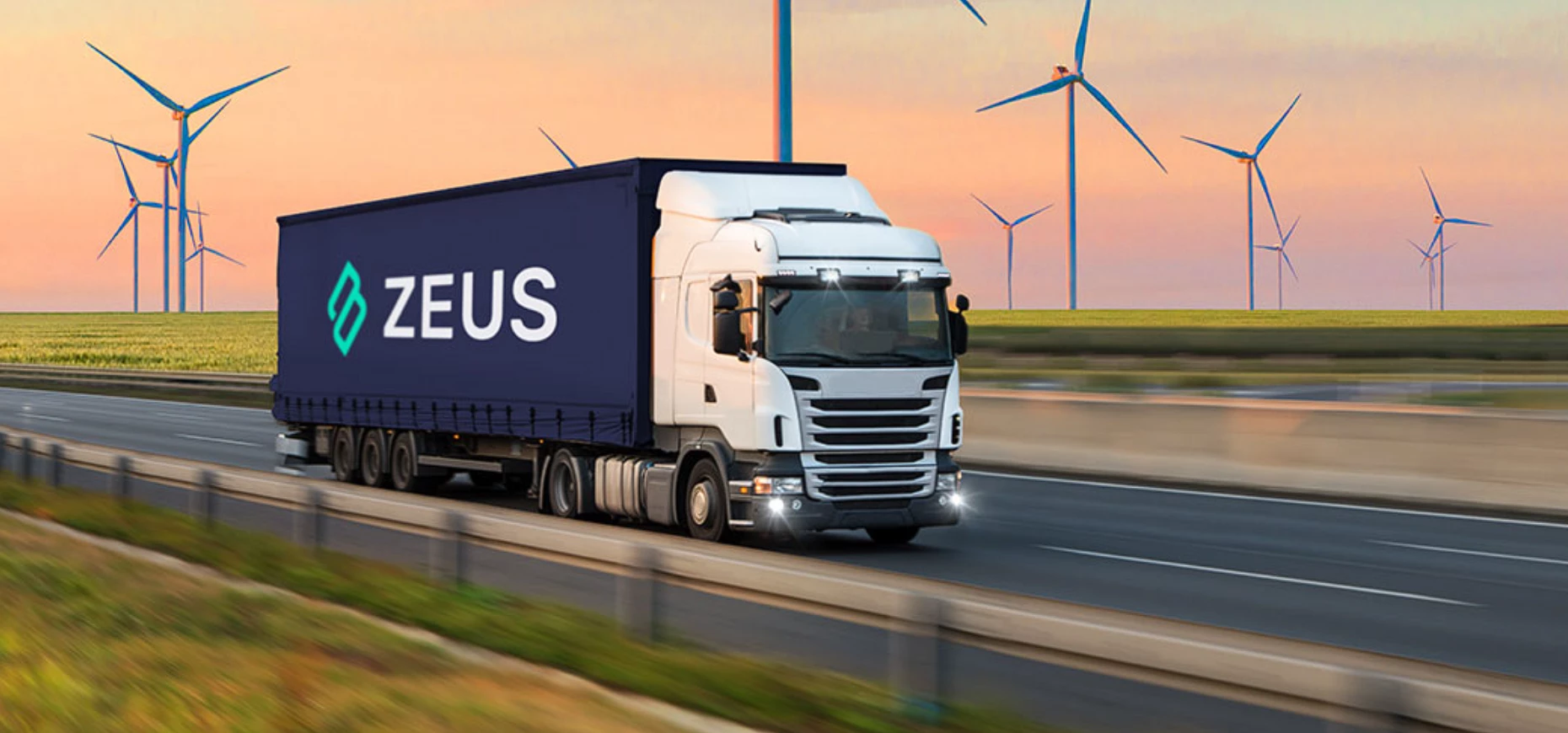 A Zeus-branded vehicle driving through a wind farm.