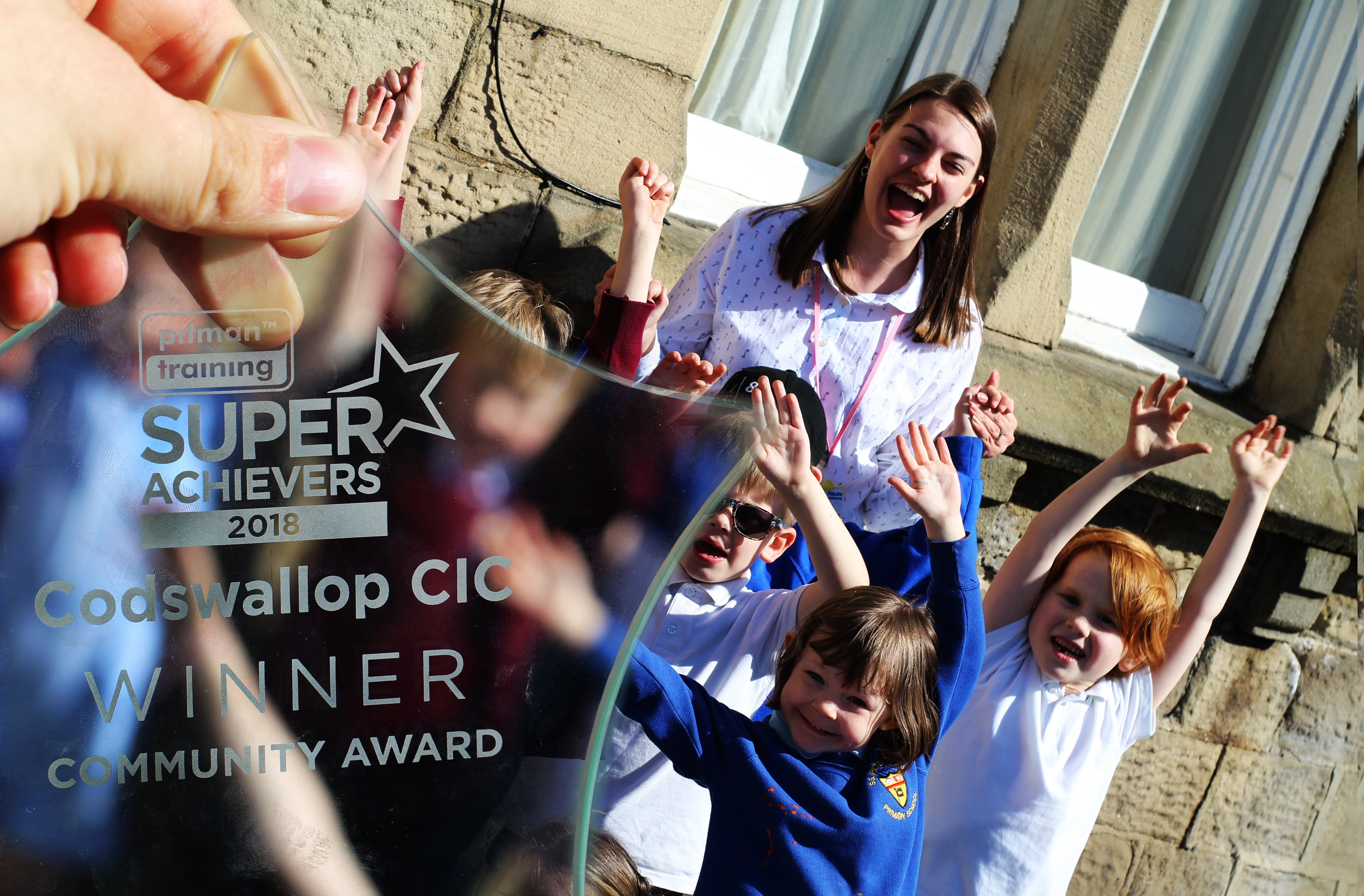 SuperAchivers Trophy with Lucy Philips, Arts Coordinator at Codswallop and a group of children. 
