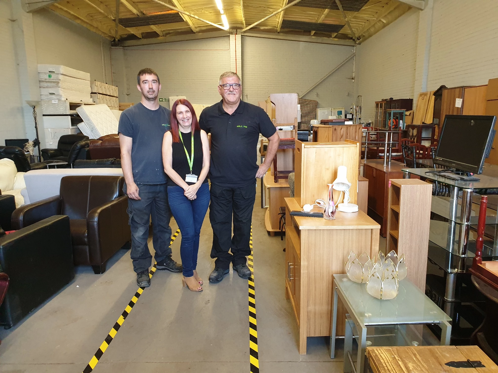 Salix Homes officers Aaron Brown, Janine Hart and David Ryan with some of the furniture that’s been diverted away from landfill sites. 