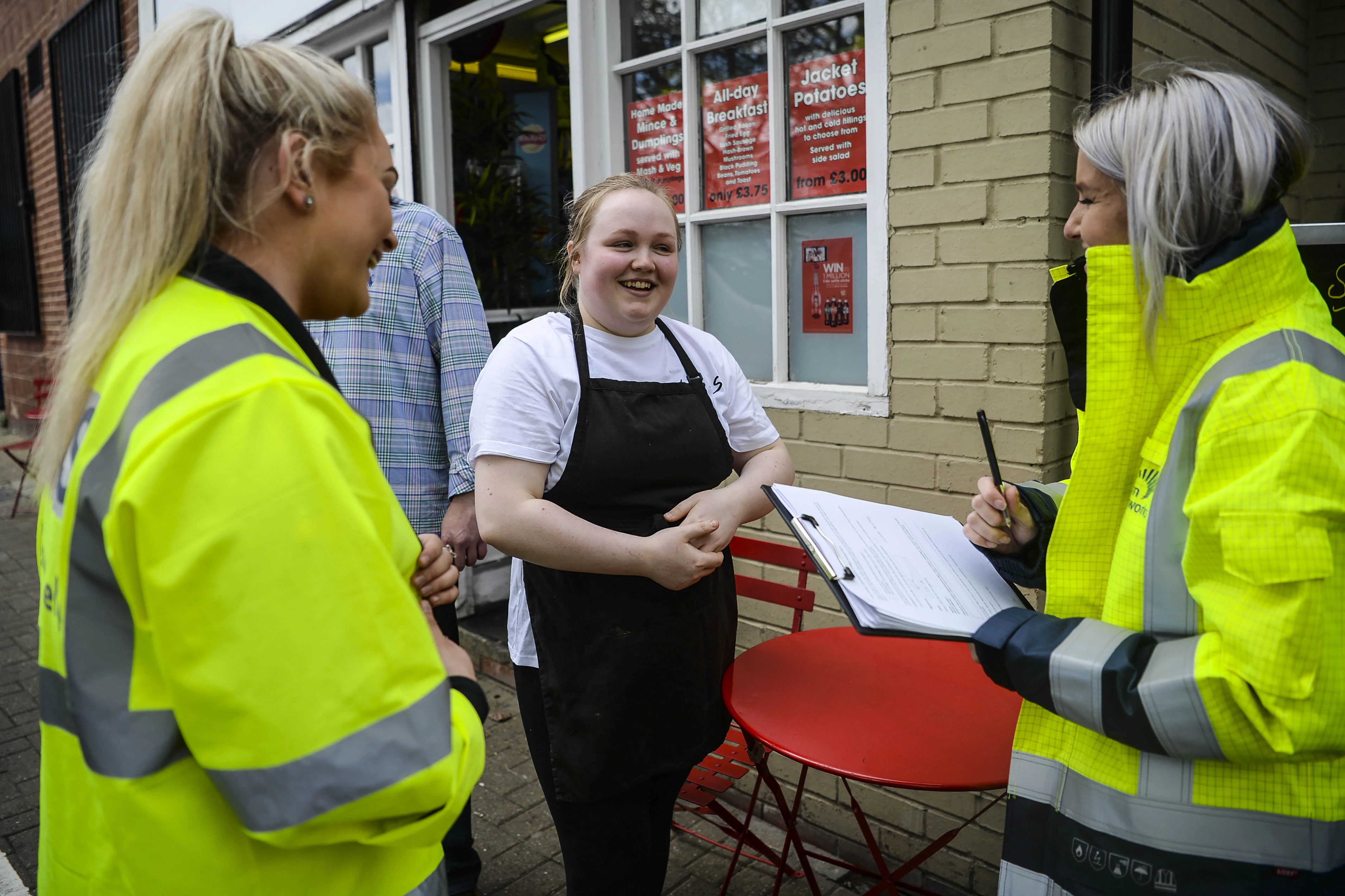 Customer Care Officers talk to local business owner