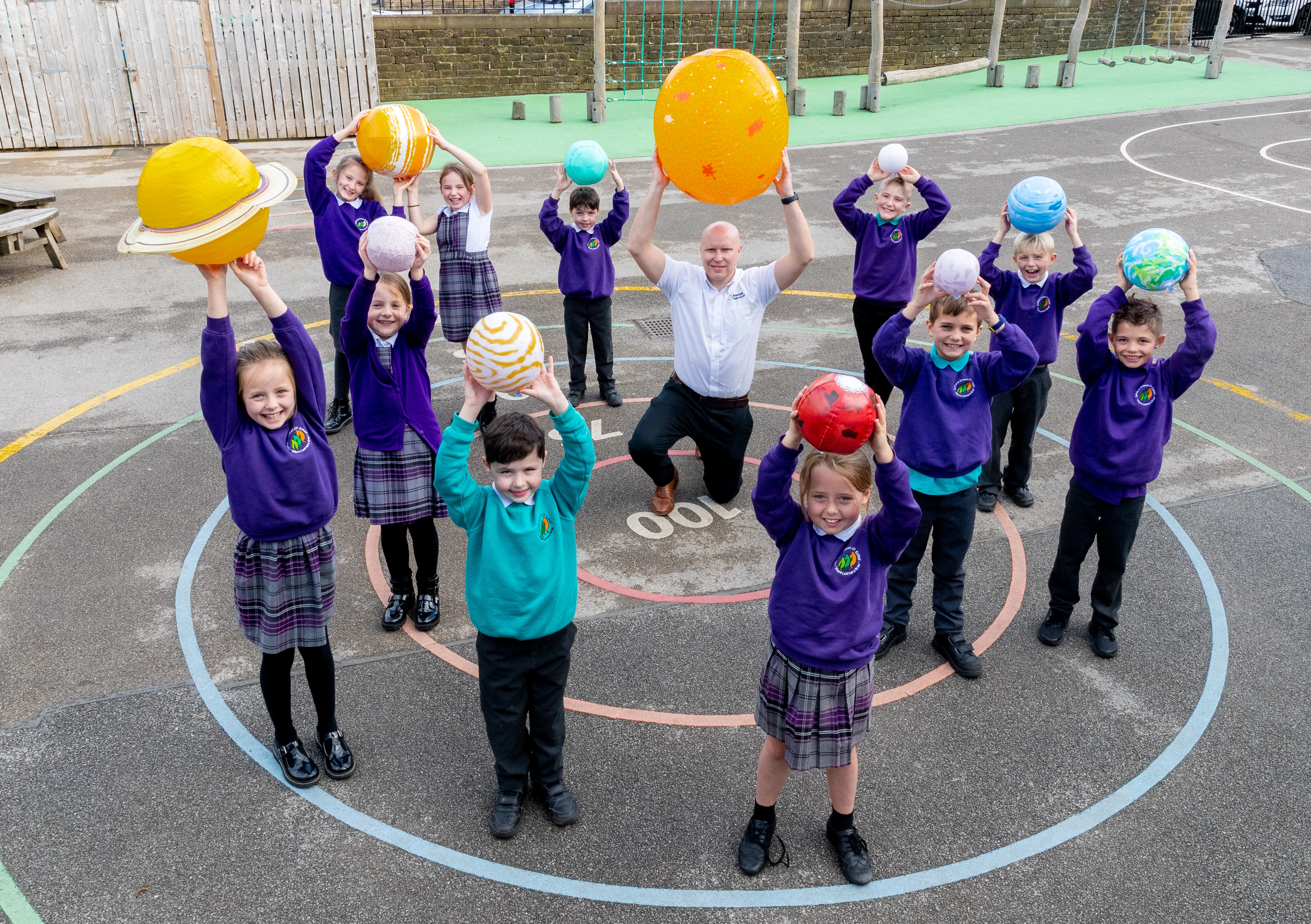 Pupils from Sutton-in-Craven Community Primary School with Daniel Marr of Airedale Chemical and an inflatable solar system.jpg