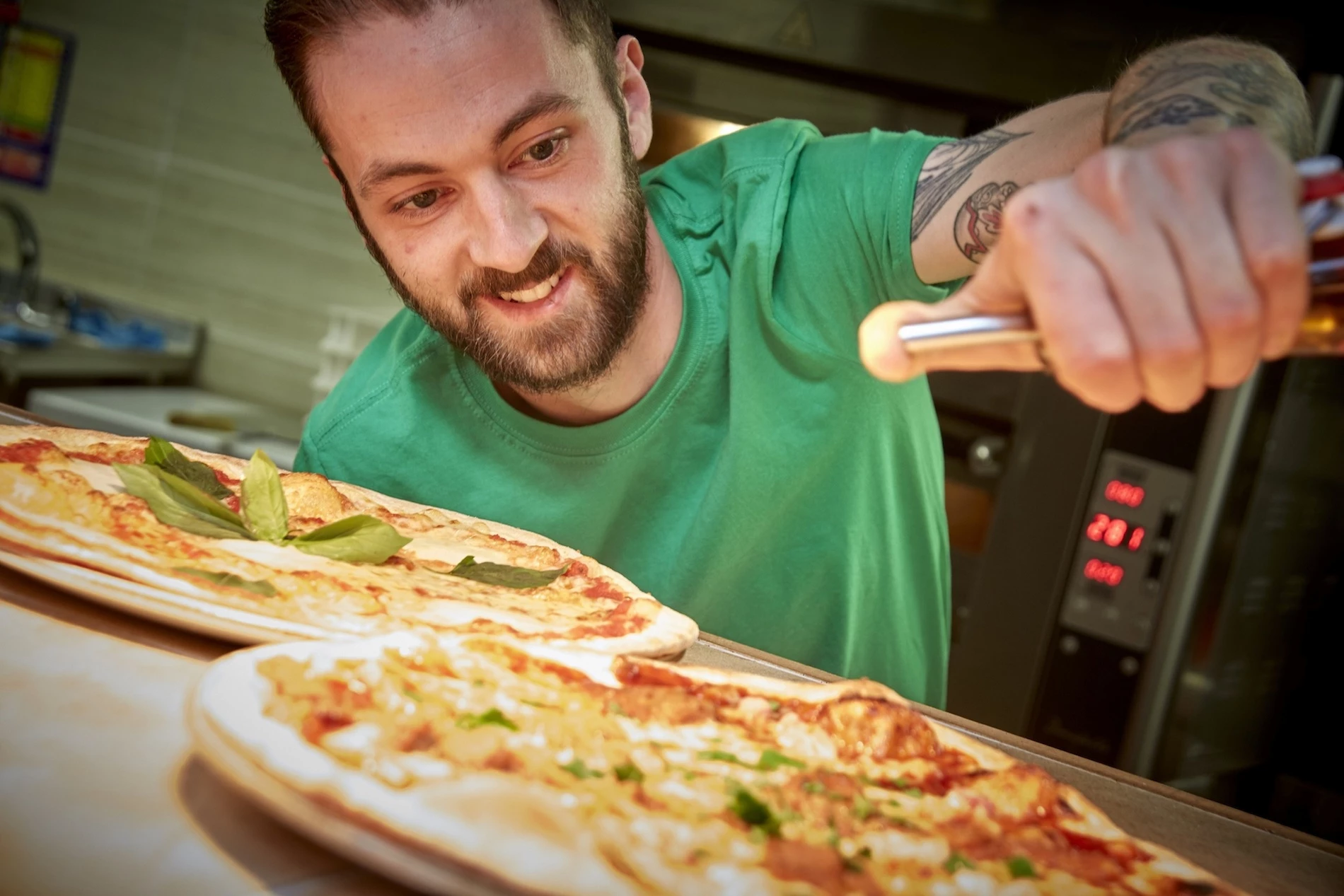Head Chef Tom Lynch prepares meals for Buca di Pizza diners.