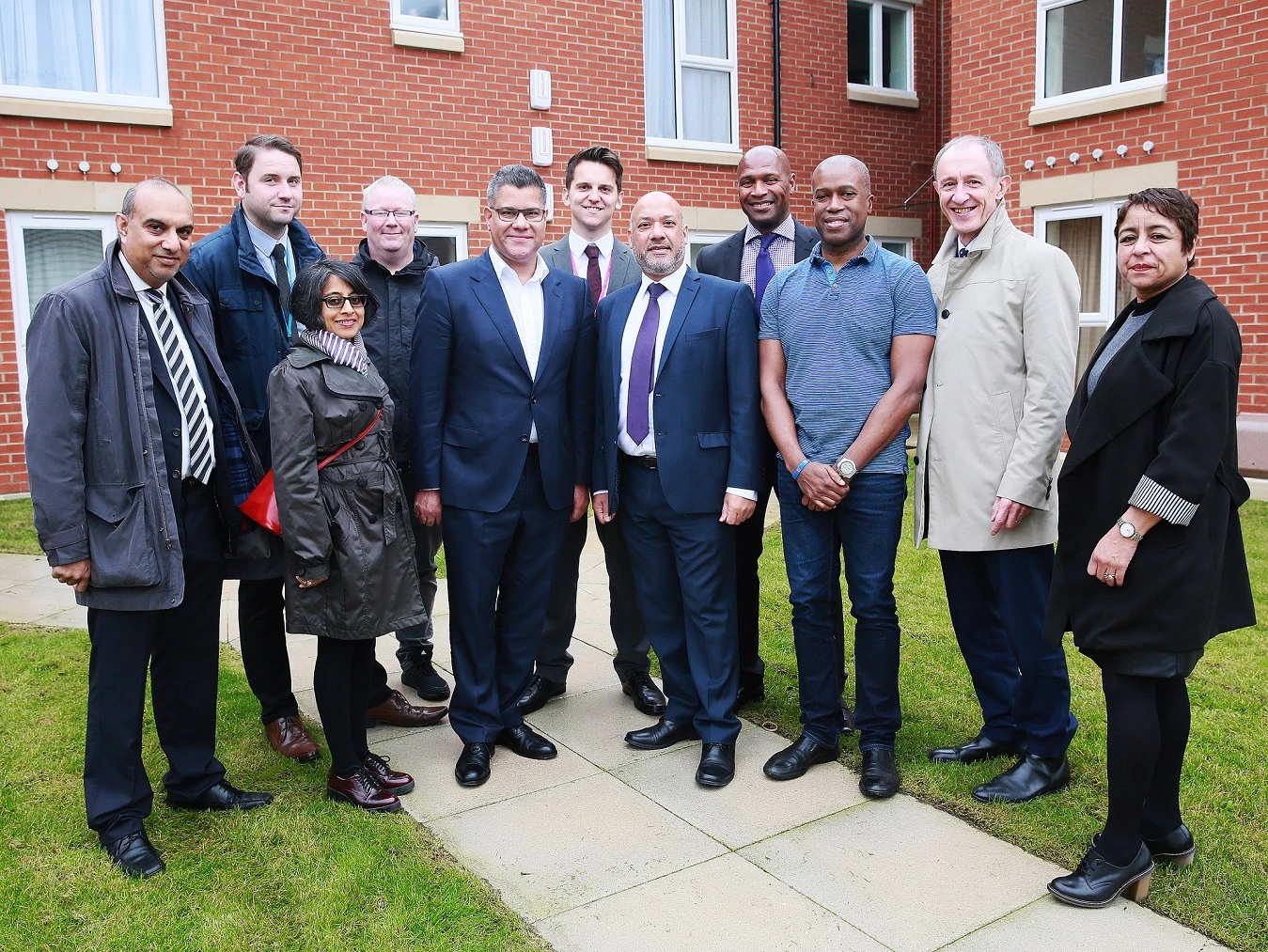 Housing Minister Alok Sharma (fifth from left) is joined by resident Ian Bailey (third from right), Unity chief executive Ali Akbor (centre), Unity board members and other partners at Holborn Court