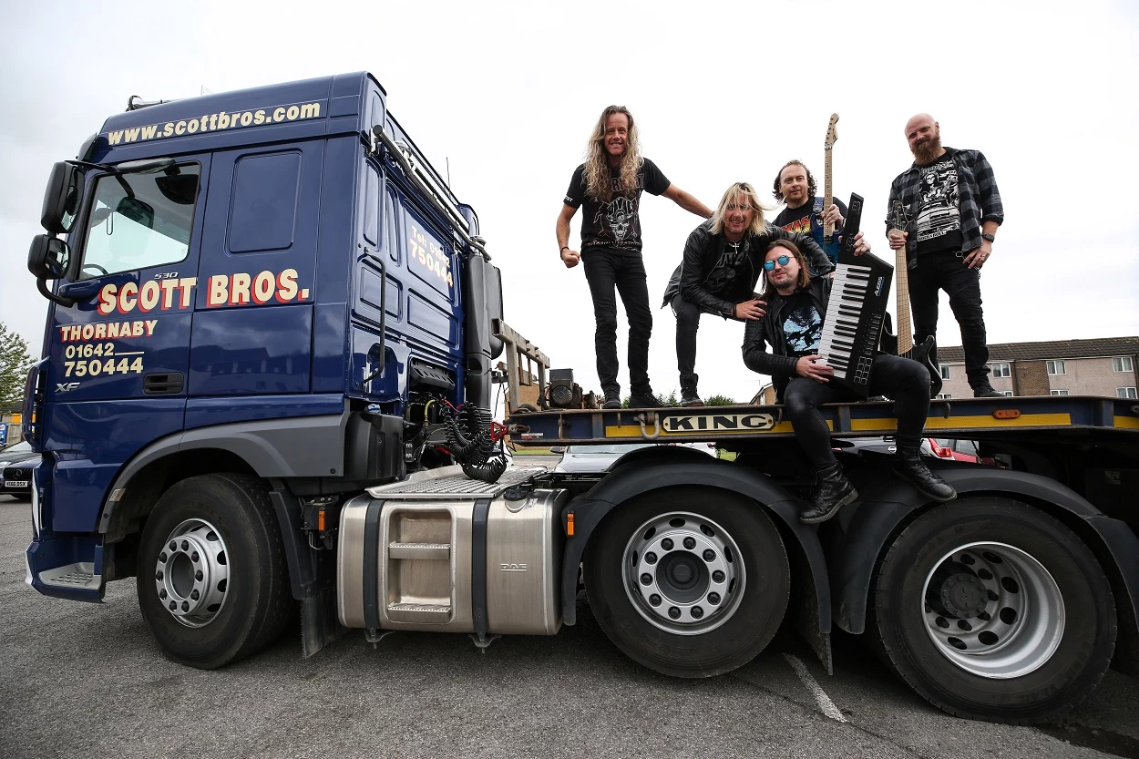 The Kill pose with Scott Bros’ new 60-tonne low loader unit during their gig 
