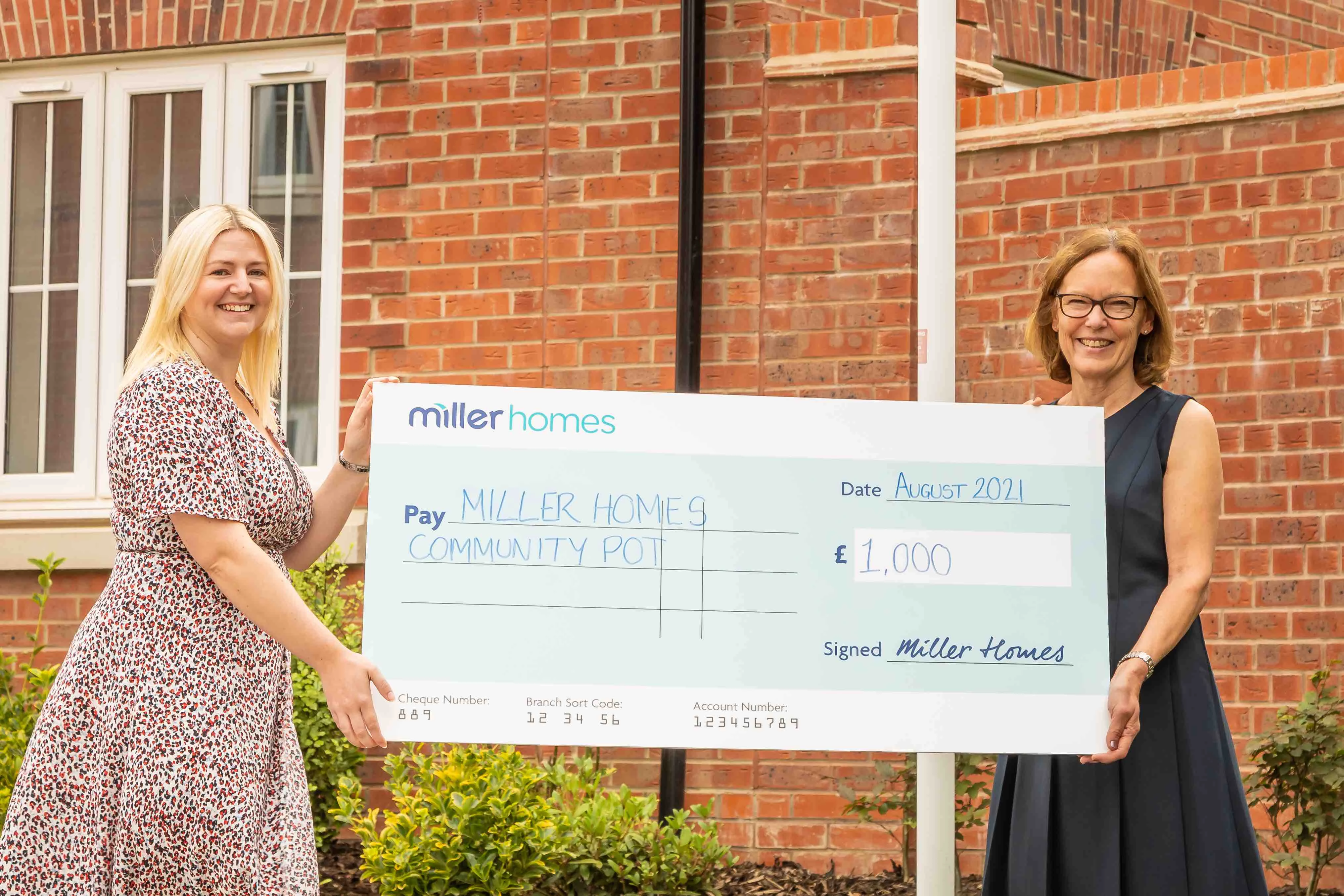 L-R Maggie White, sales manager at Miller Homes presenting the donation to Janette Butler, partnership development manager at Walton Charity