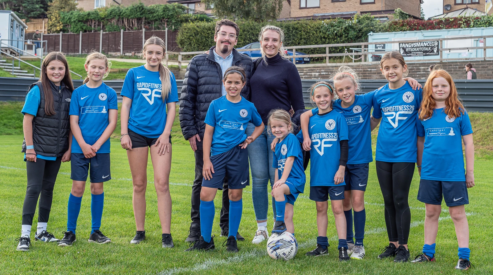 © Halifax FC Women Limited - Daniel Thomas Loitz with his partner and girls of the Halifax FC Women Academy.