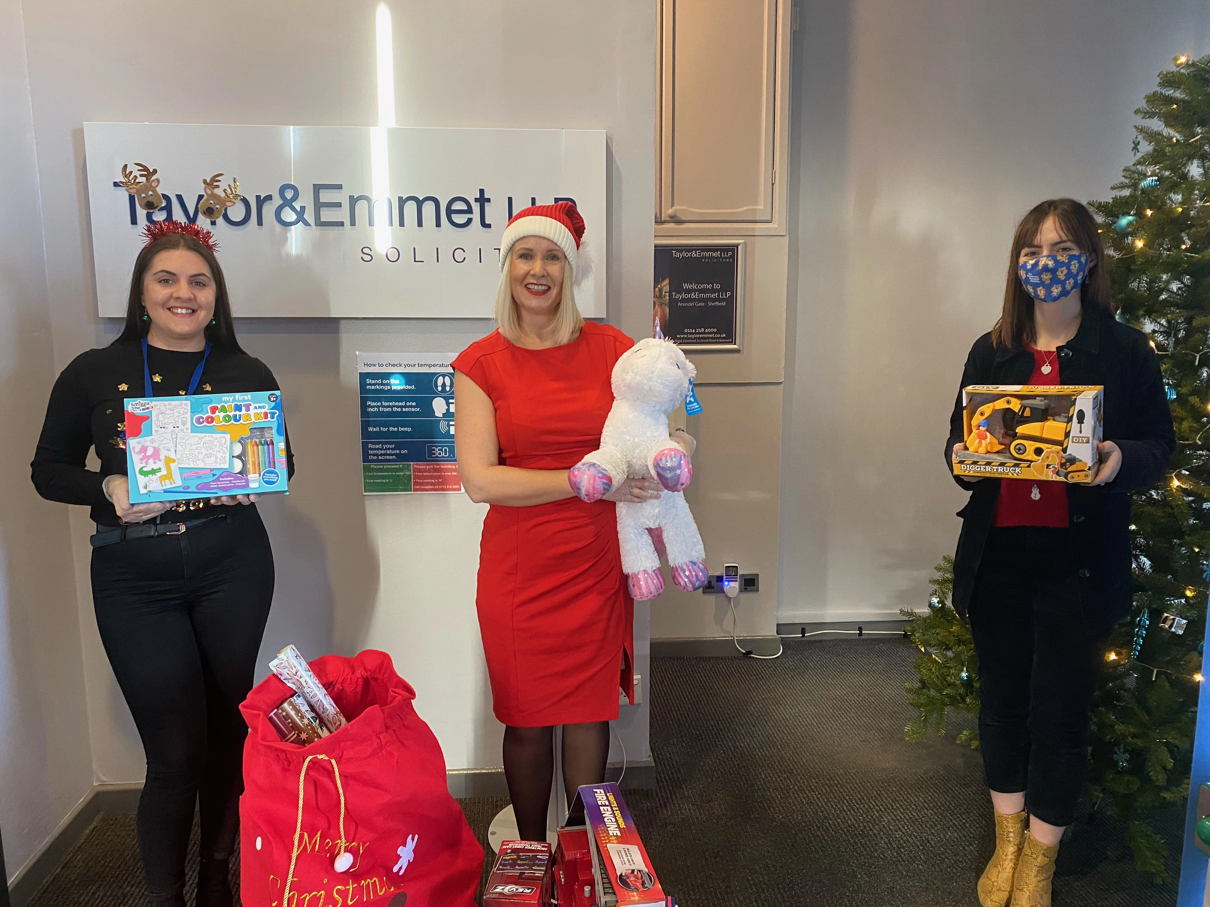 (Left to right): Taylor&Emmet's Lauren Partridge and Sharna Poxon hand over toys collected by the firm to Sophie Coburn of The Children's Hospital Charity. 