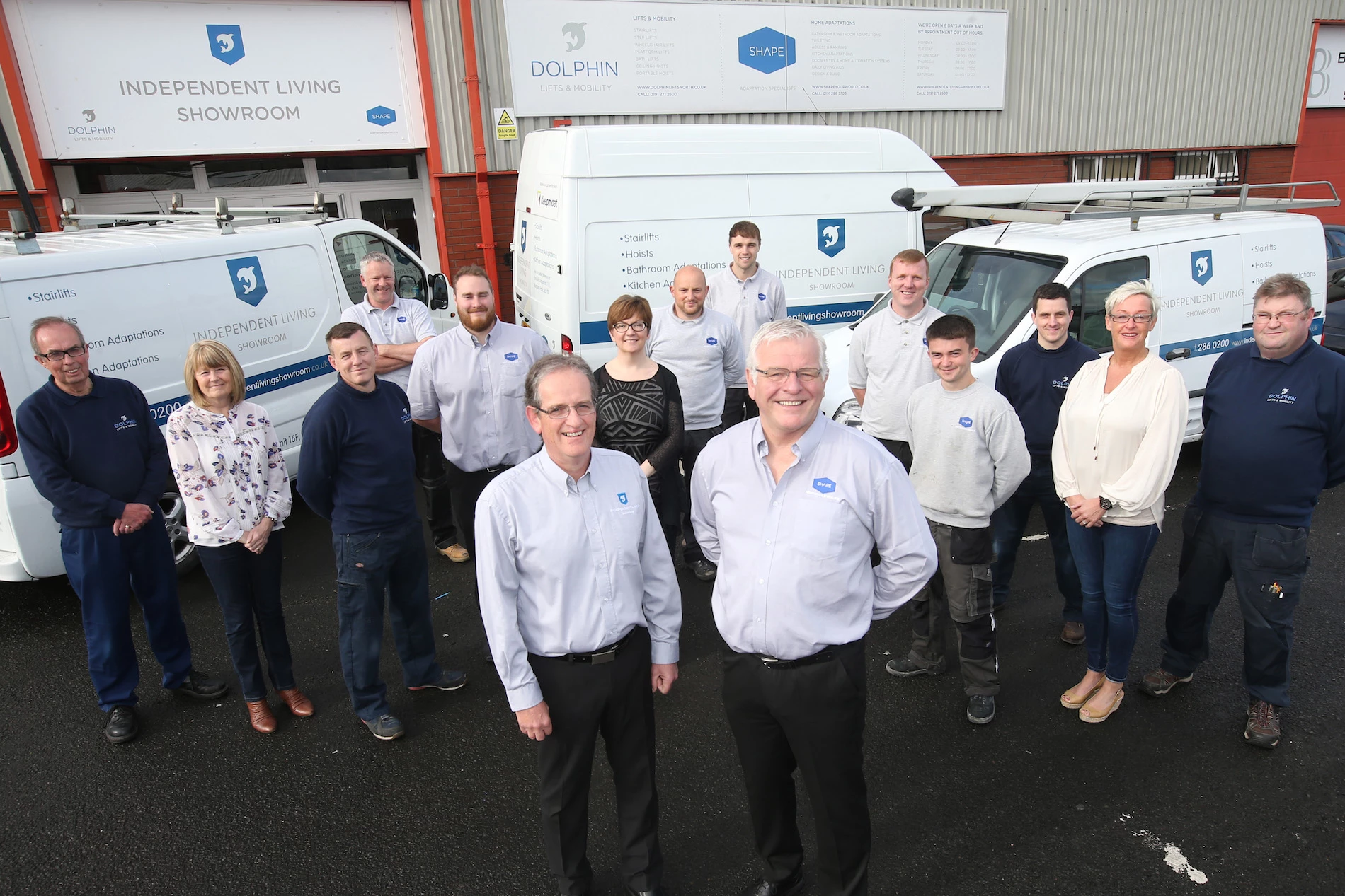 The ILS team with their new vehicles outside the revamped ILS showroom.