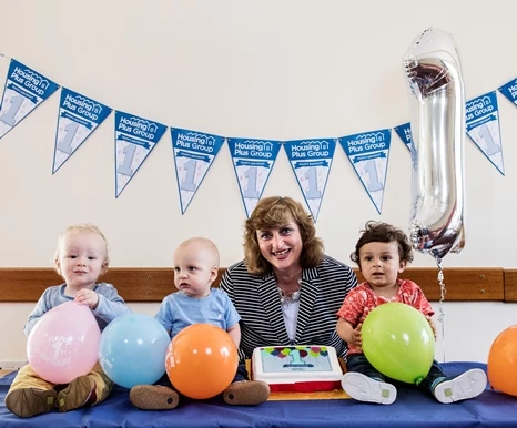 CEO Sarah Boden celebrating the first birthday of Housing Plus Group with one-year-olds William, Dawson and Marley