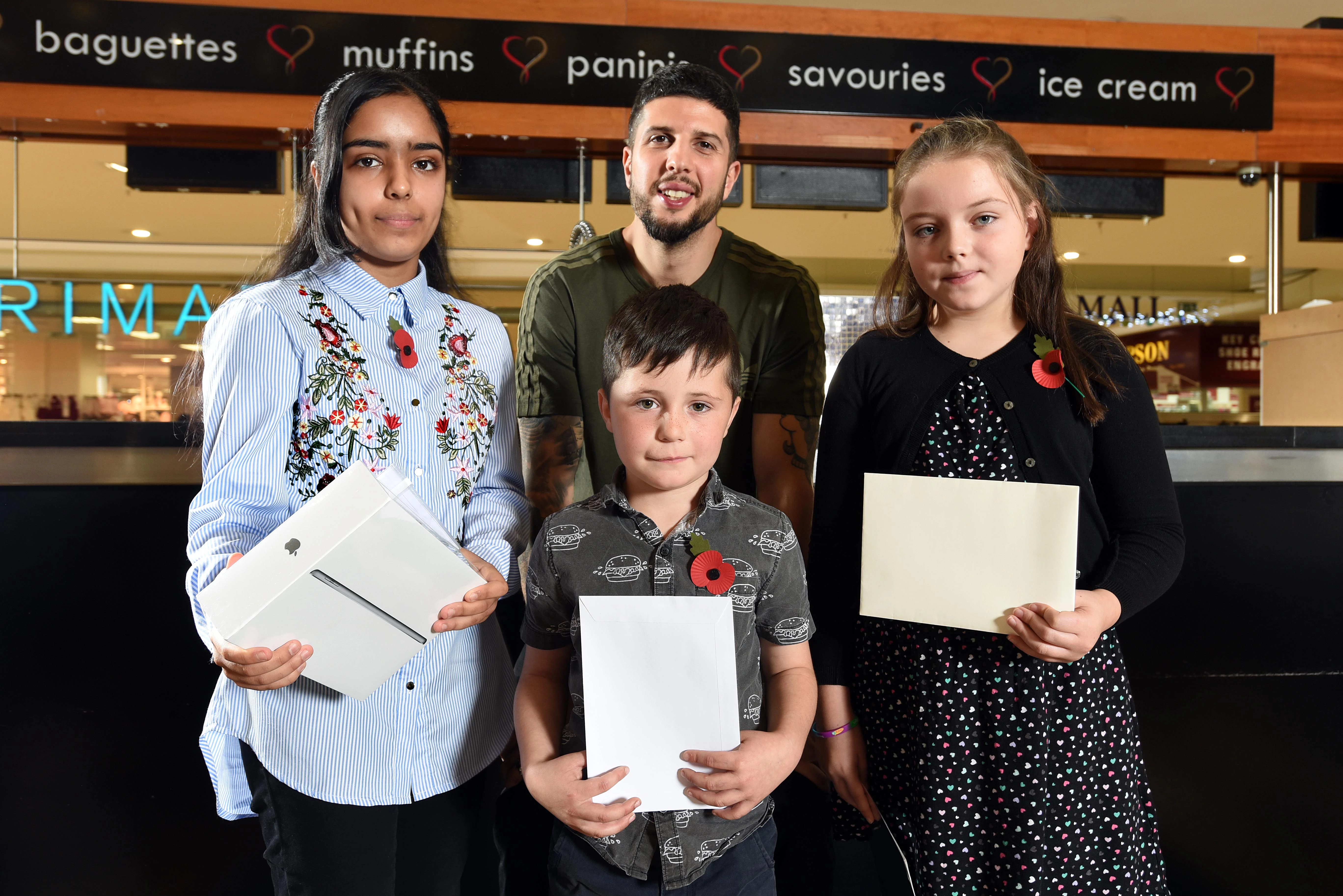 The winners of Kirkgate Shopping's Young War Poet competition with Anthony Anaxagorou