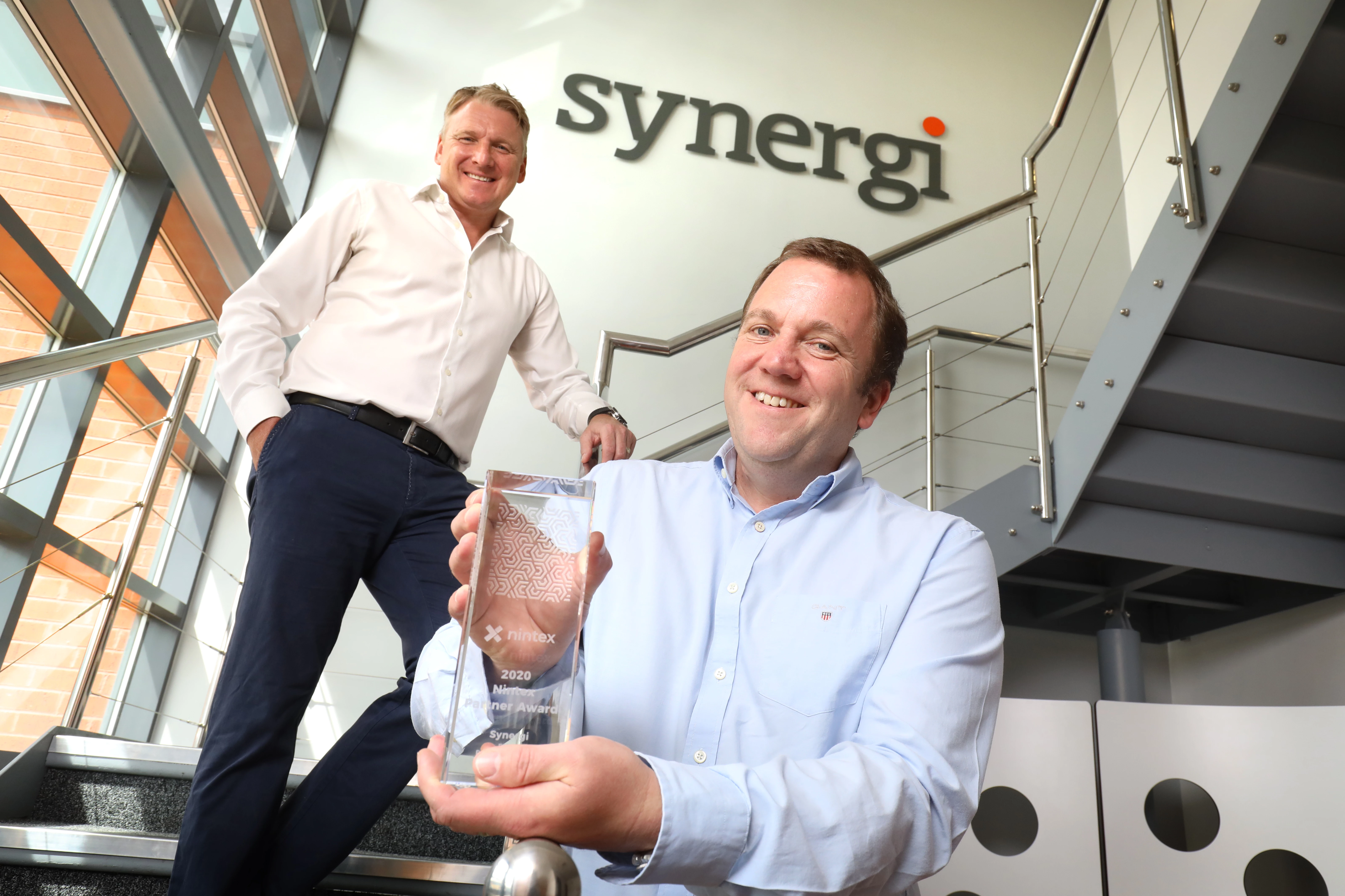 Justin Short, COO, and Peter Joynson, CEO of Synergi with their latest Nintex Partner Award