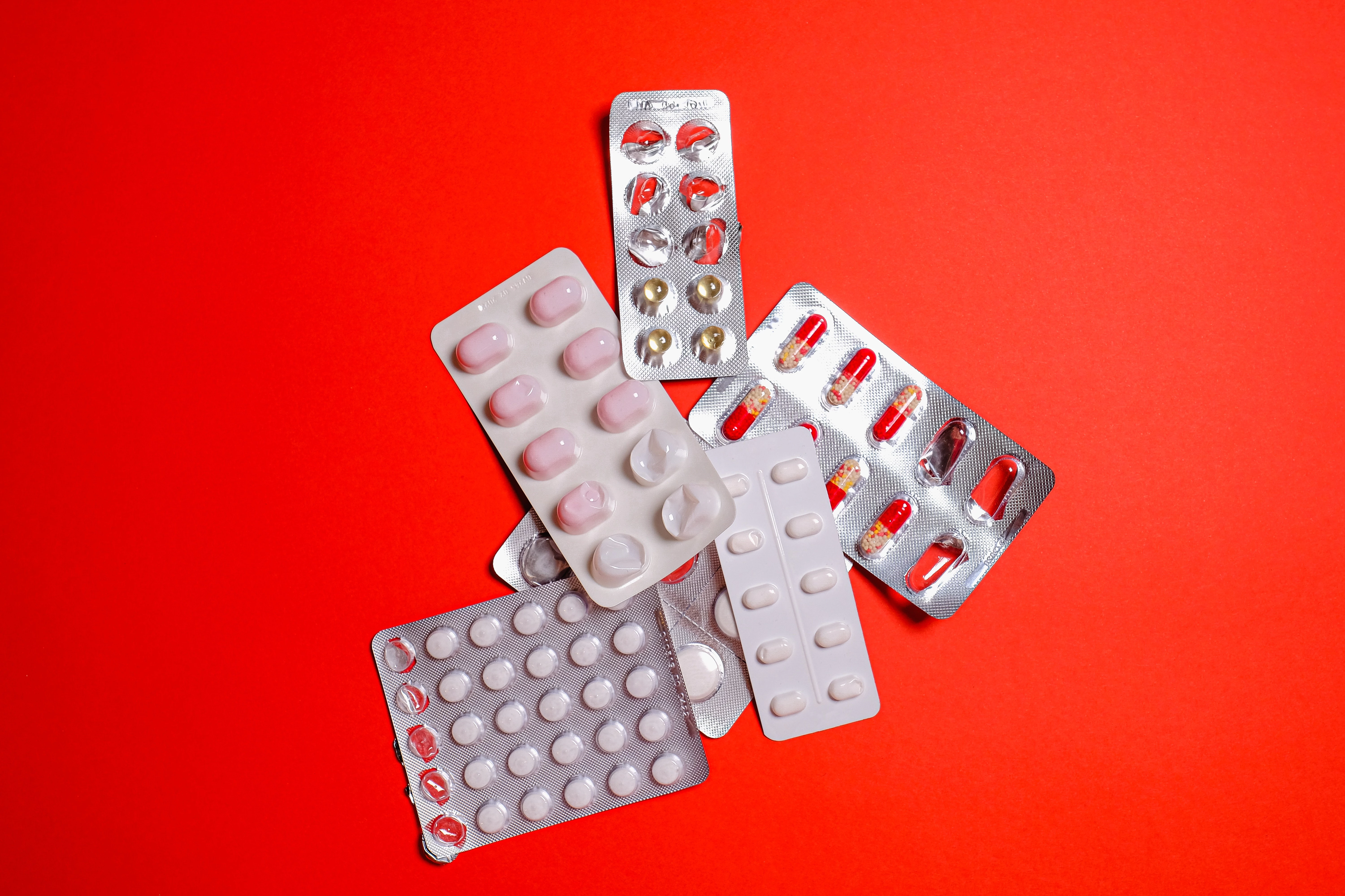 pills on red background.