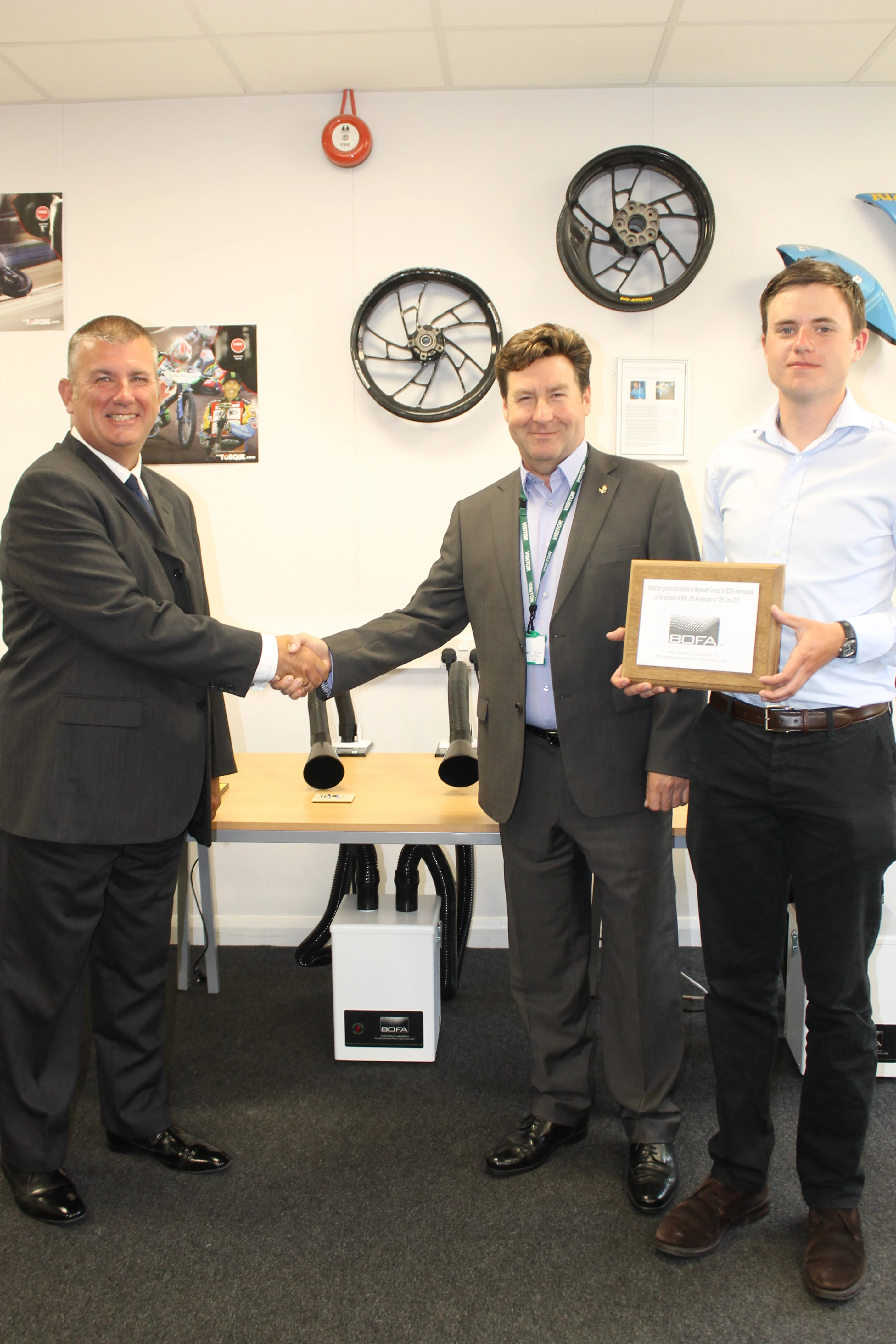 Left to right: Brian Oman, Head of Engineering, Weymouth College, shaking hands with Tony Lockwood, MD BOFA International and Callum Courtney