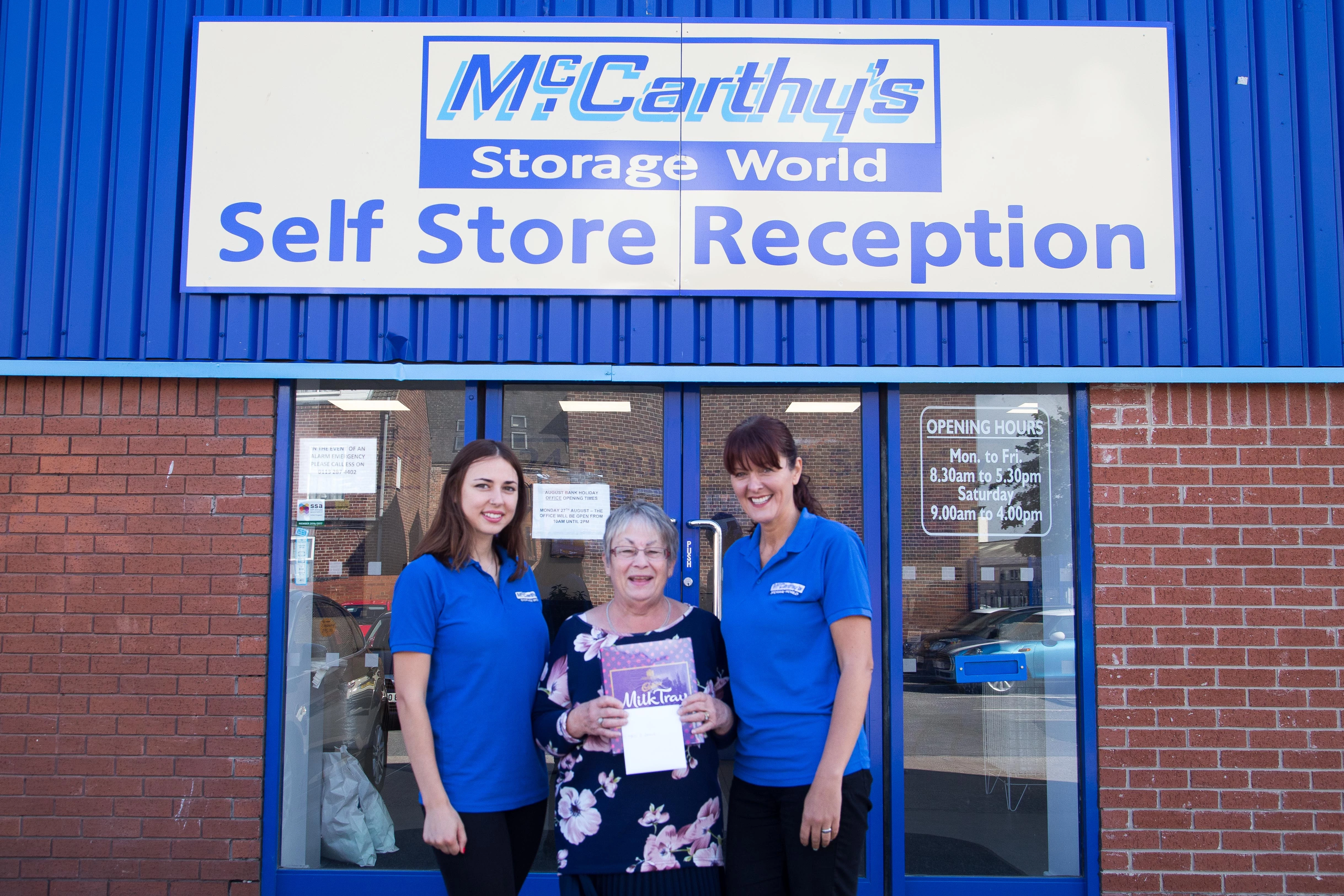Staff at McCarthy's Storage World in Wakefield surprised customer Catherine Davis with a gift voucher as part of its 50 Good Deeds. L-R Santa Nekrasova, Catherine Davis, Wendi Wright