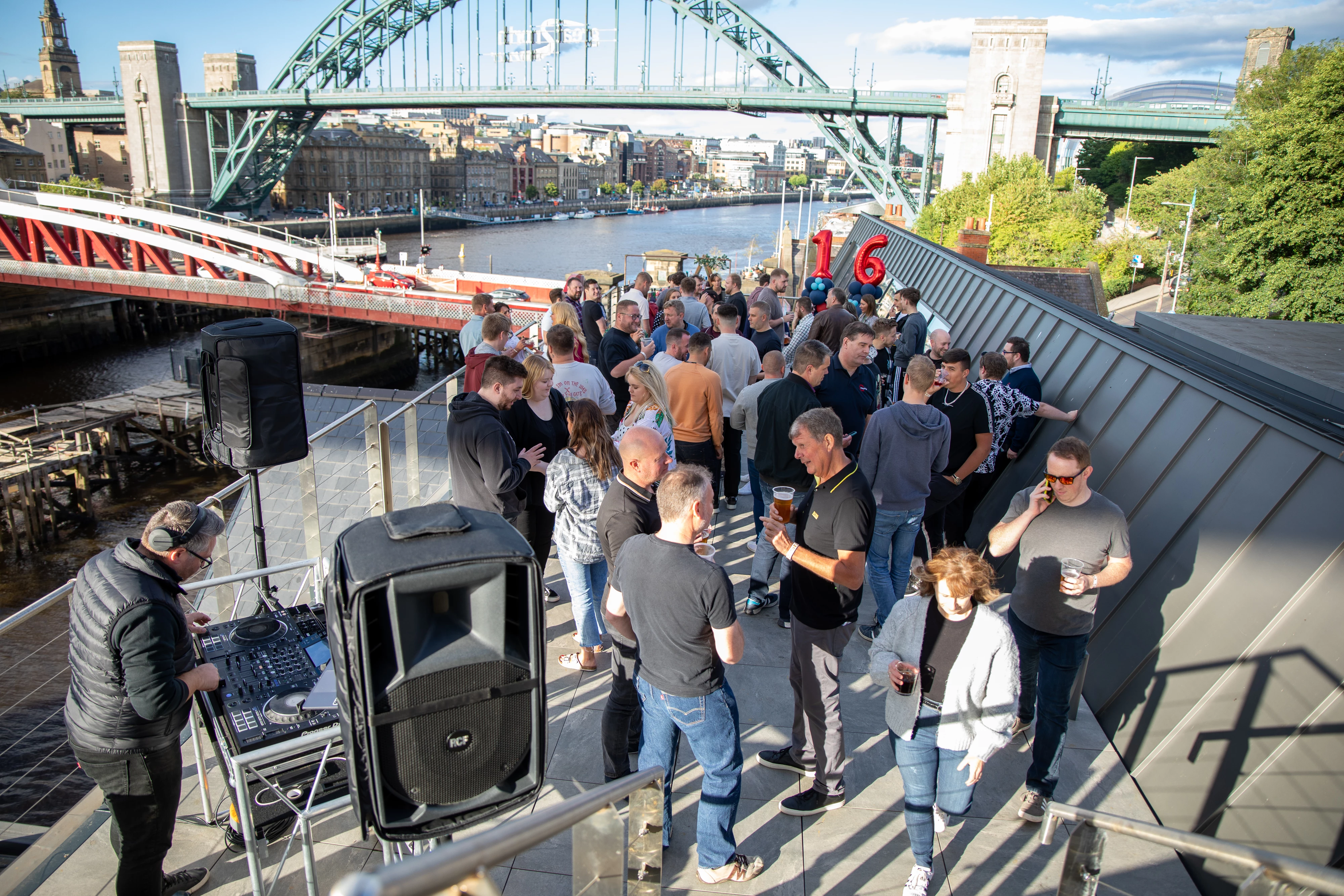 Employees from Aspire Technology Solutions celebrate on the rooftop of their HQ at Pipewell Quay, Gateshead.