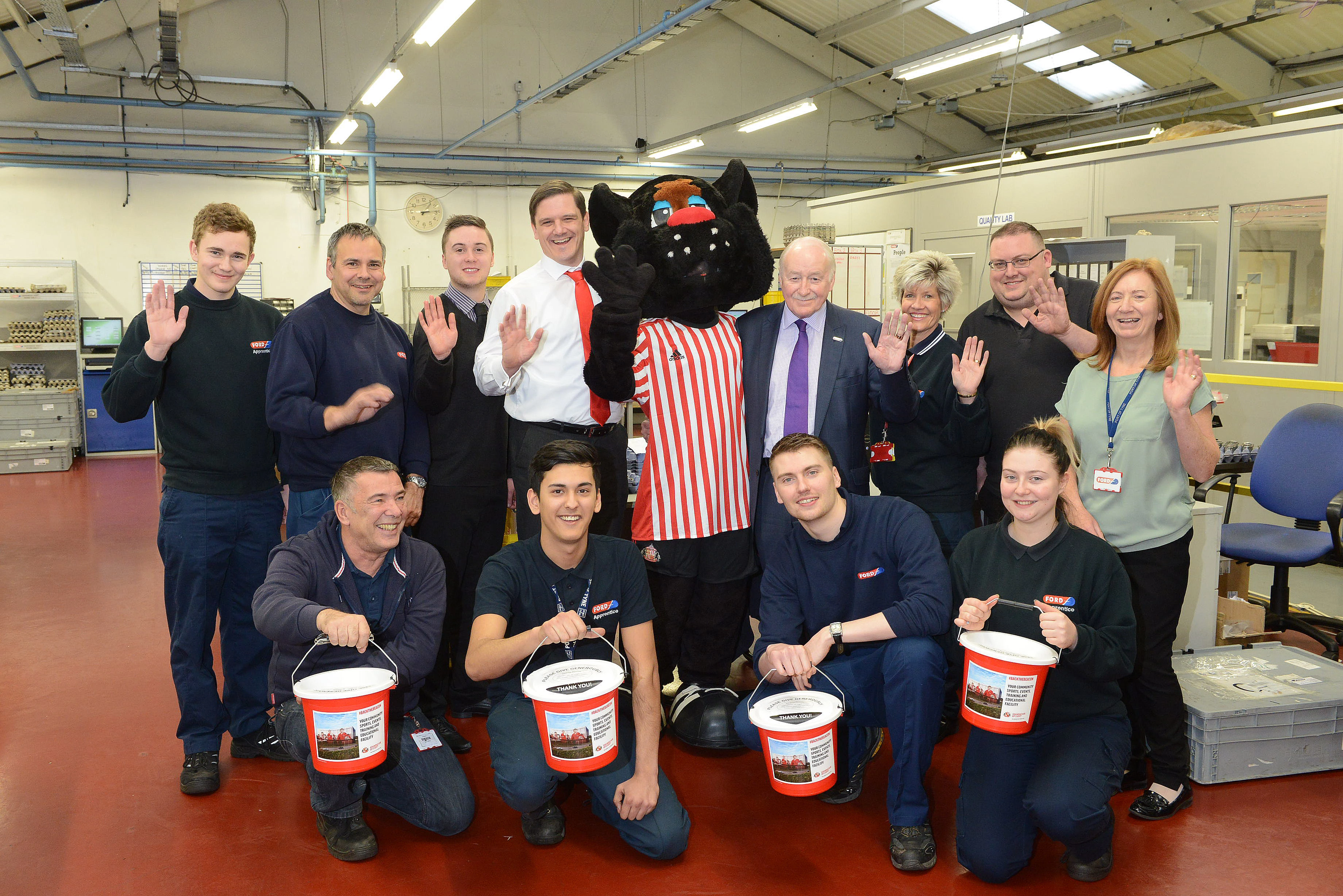 Geoff Ford alongside workers, the Foundation's James Burman and SAFC mascot Samson