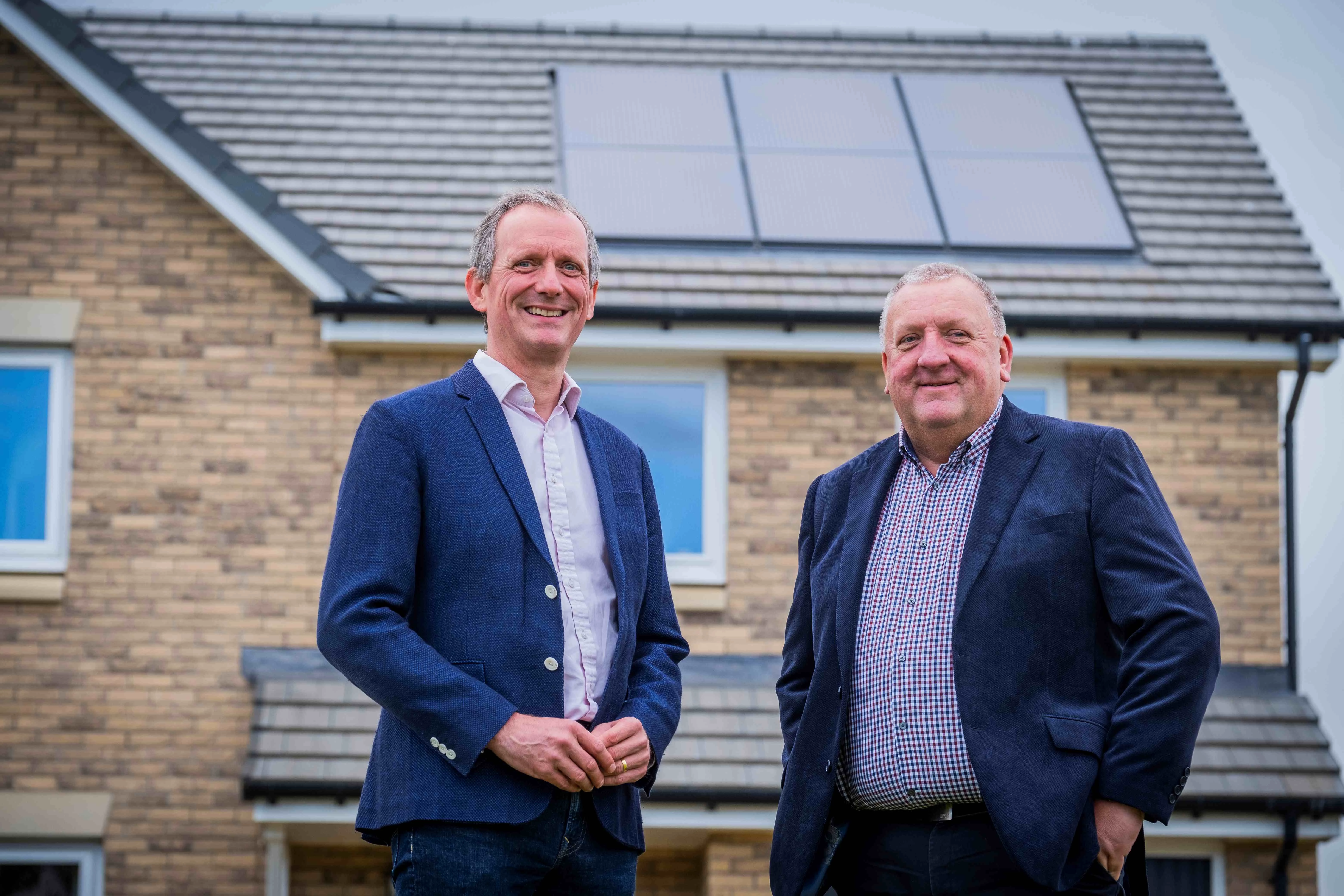 Robin Peters, CEO of Snugg and Paul Denton, CEO of Scottish Building Society outside an energy efficient property in west of Edinburgh
