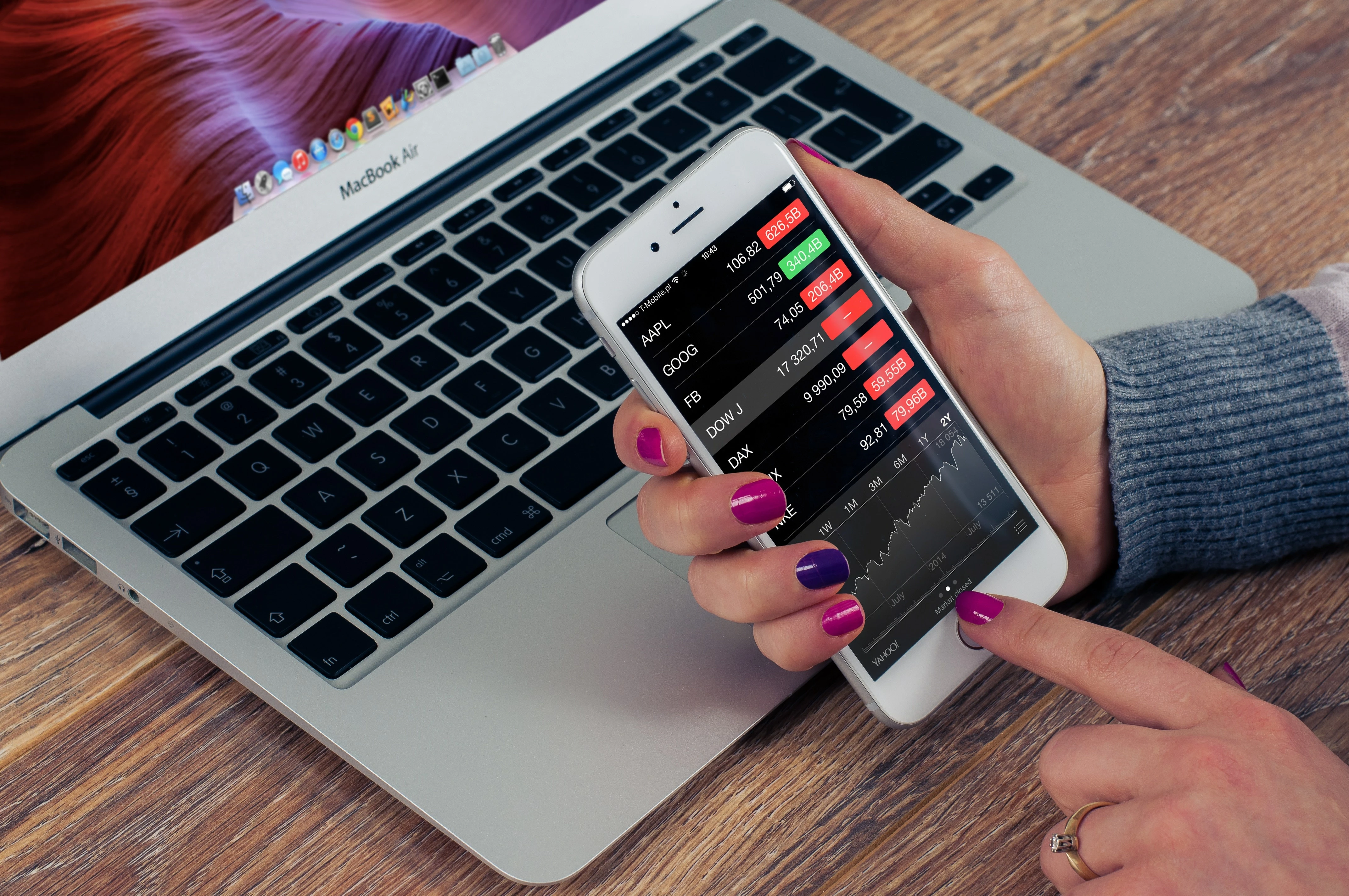 Photo of a woman looking at investments on her smartphone