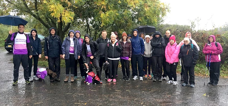 UNW staff battling the rain as they begin the 27.5-mile challenge in Warkworth