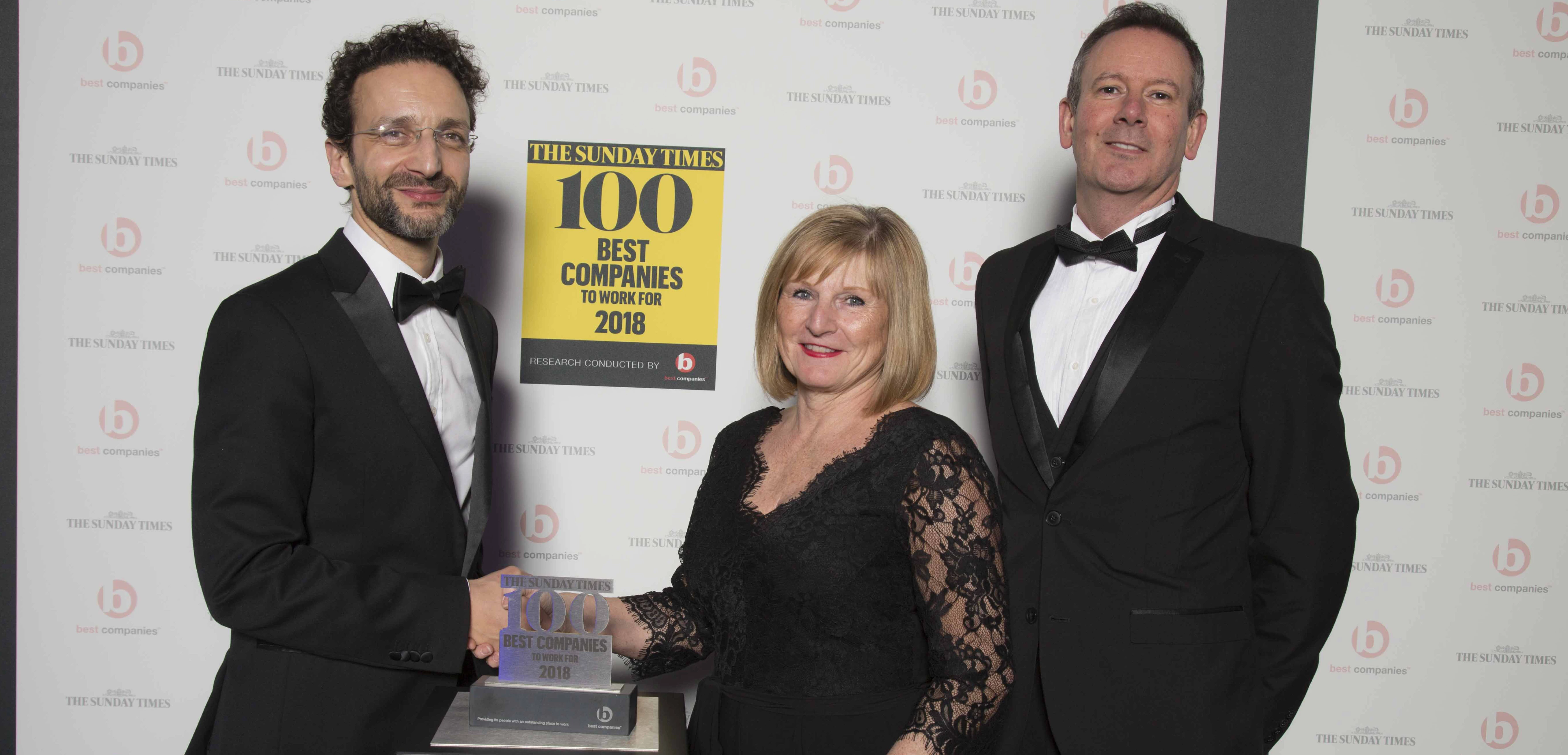 Left to right Nick Rodrigues, deputy editor, The Sunday Times 100 Best Companies presenting the award to Carole Carson, CEO & Adrian Fanthham, Chief Finance Officer.