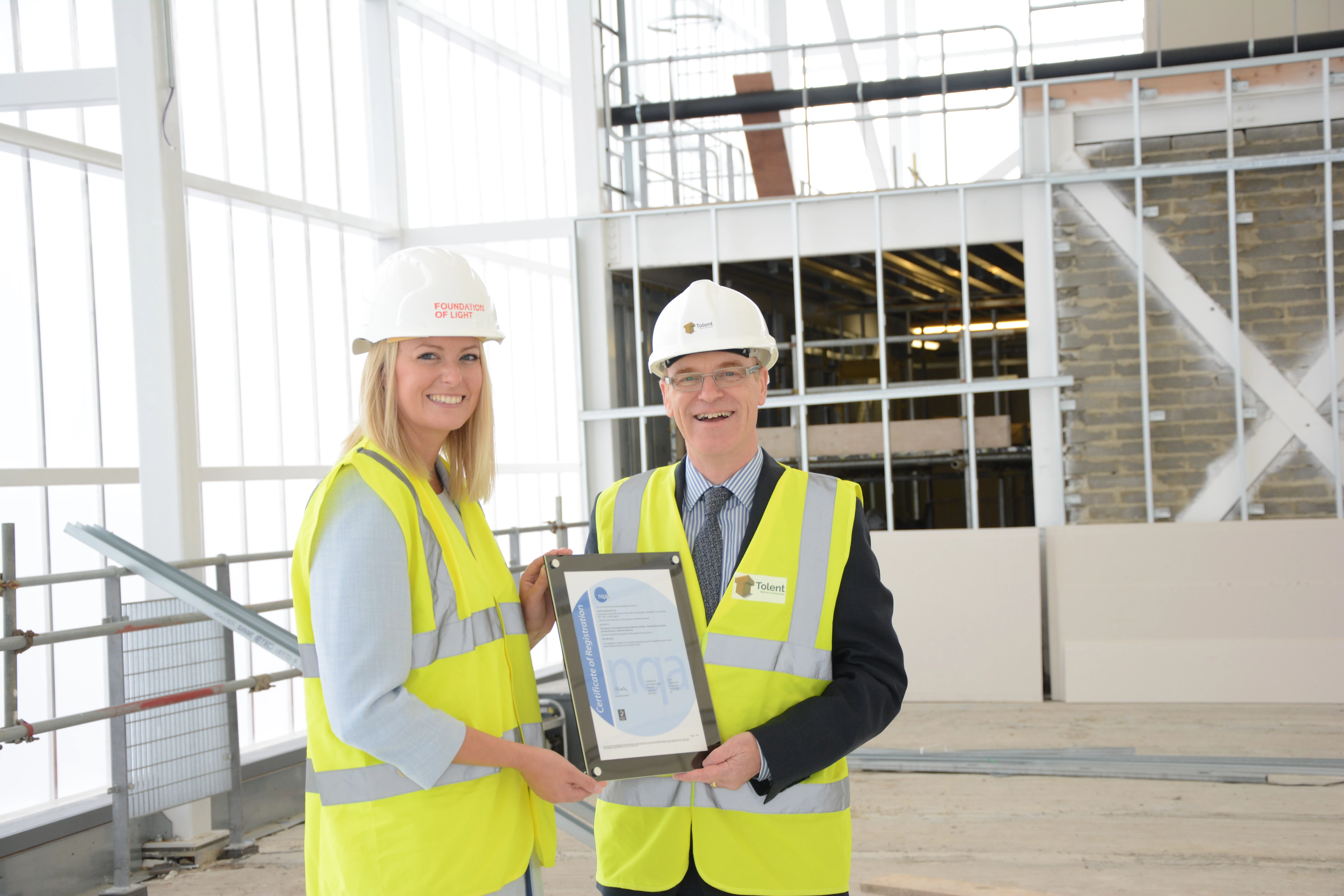 Paul Webster (right), Director at Tolent receives certificate from Laura Cottom (left) of NQA