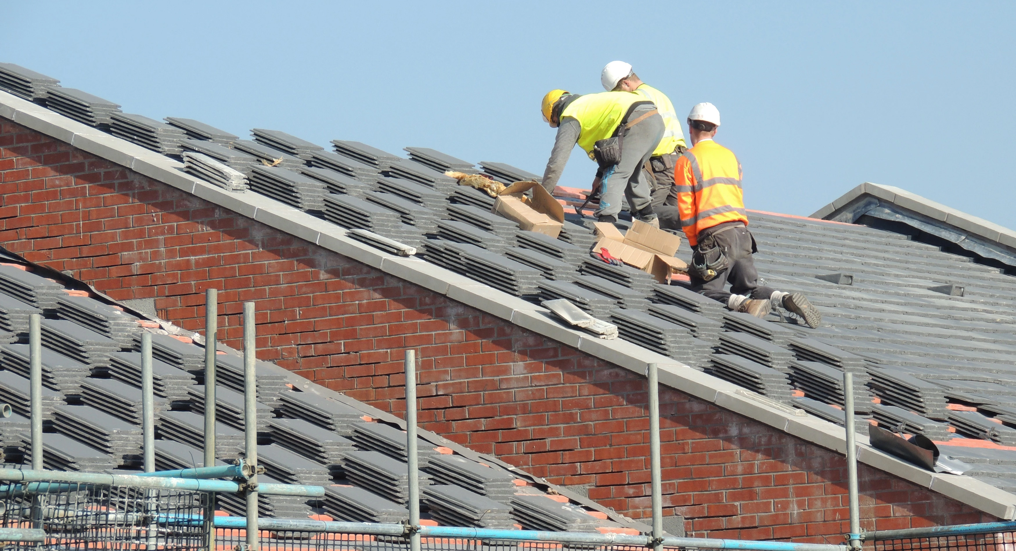 Builders laying tiles and accessories