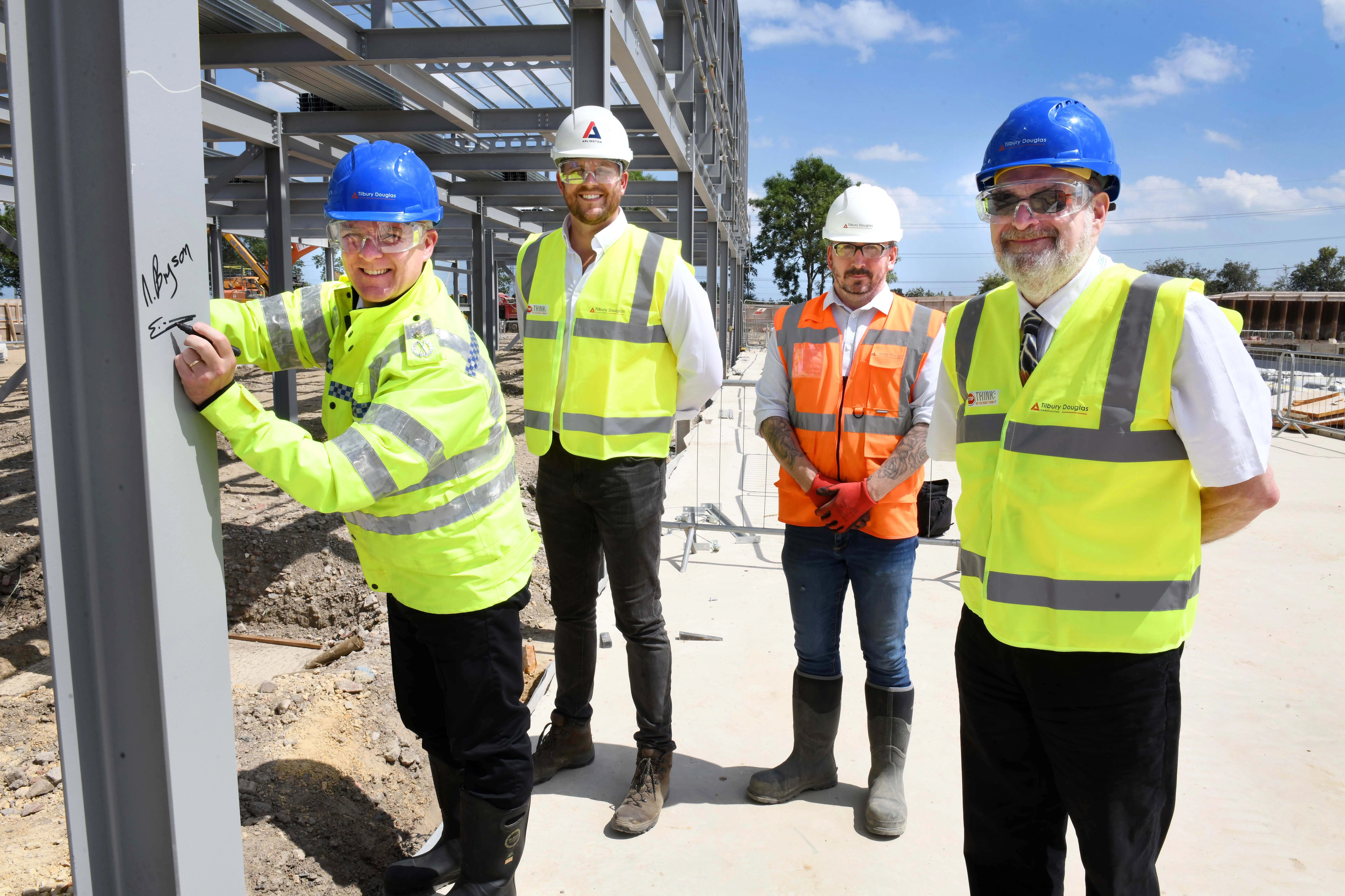 L-R: Deputy CC Ciaron Irvine signs the steel frame watched by Arlington Real Estate’s Dean Cook, Eddie Wooton, Tilbury Douglas Project Manager, and Deputy Police and Crime Commissioner Nigel Bryson.
