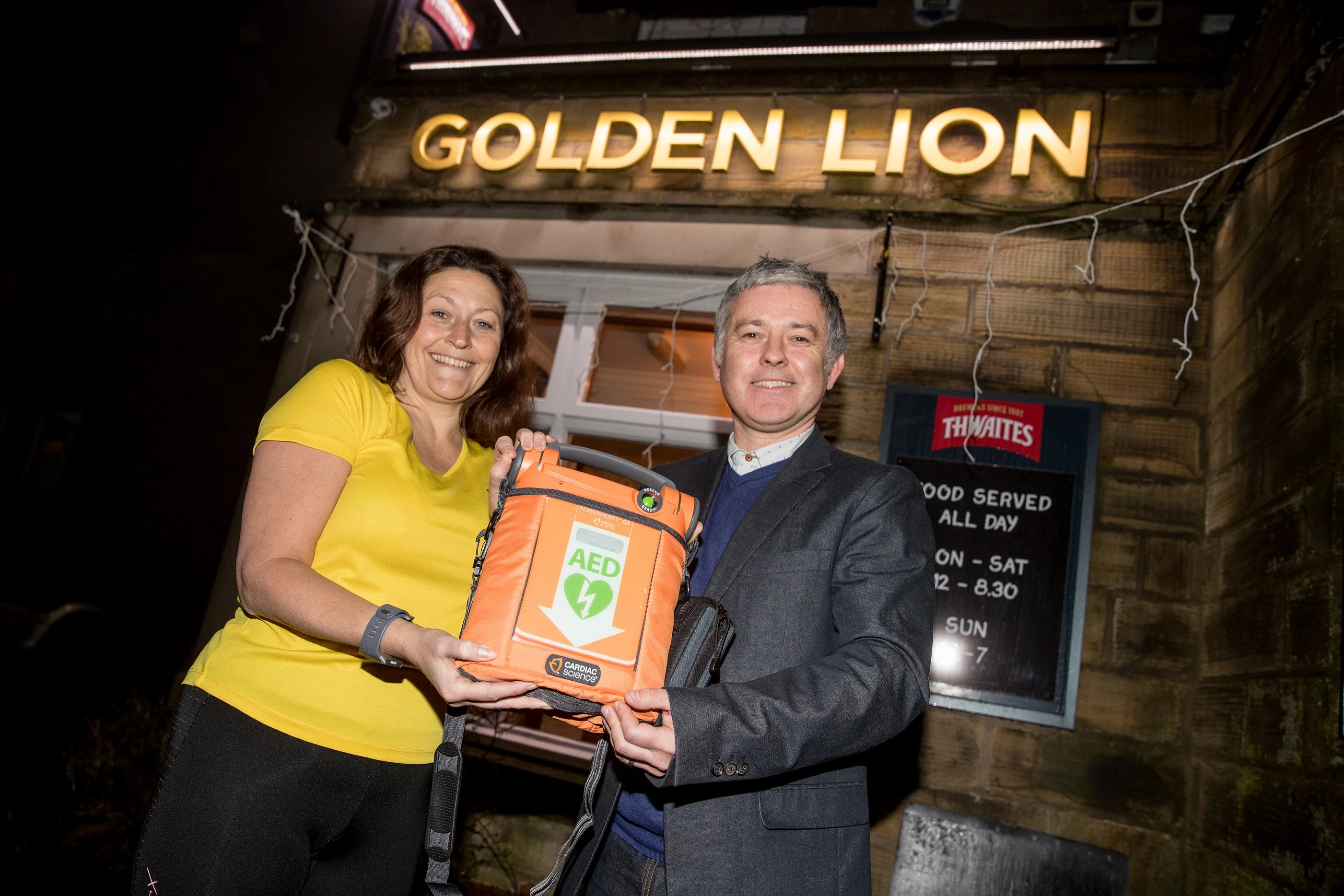 Shelby Williams with Kevin Garvey and the newly donated defibrillator