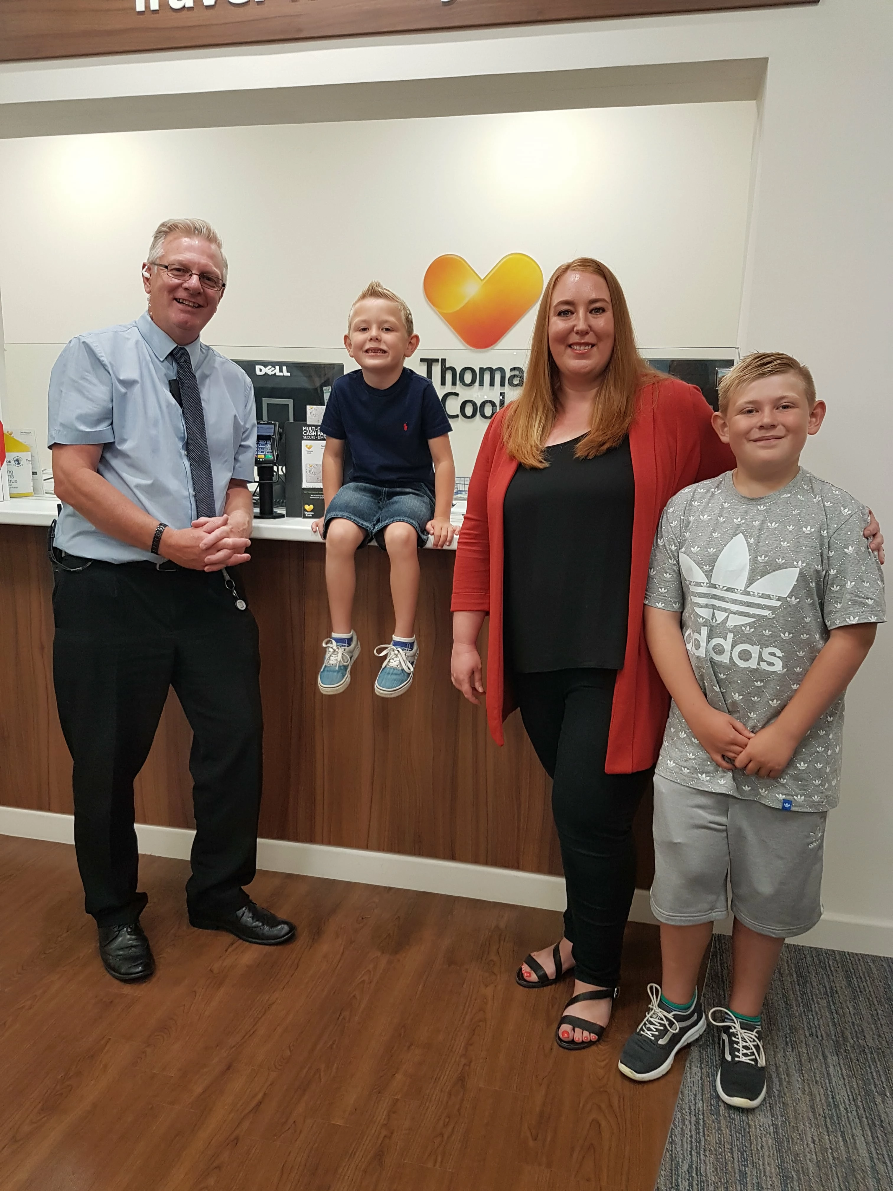 Annette Siddall and family with Alhambra Centre Manager John Tarrant, collecting her prize from Thomas Cook