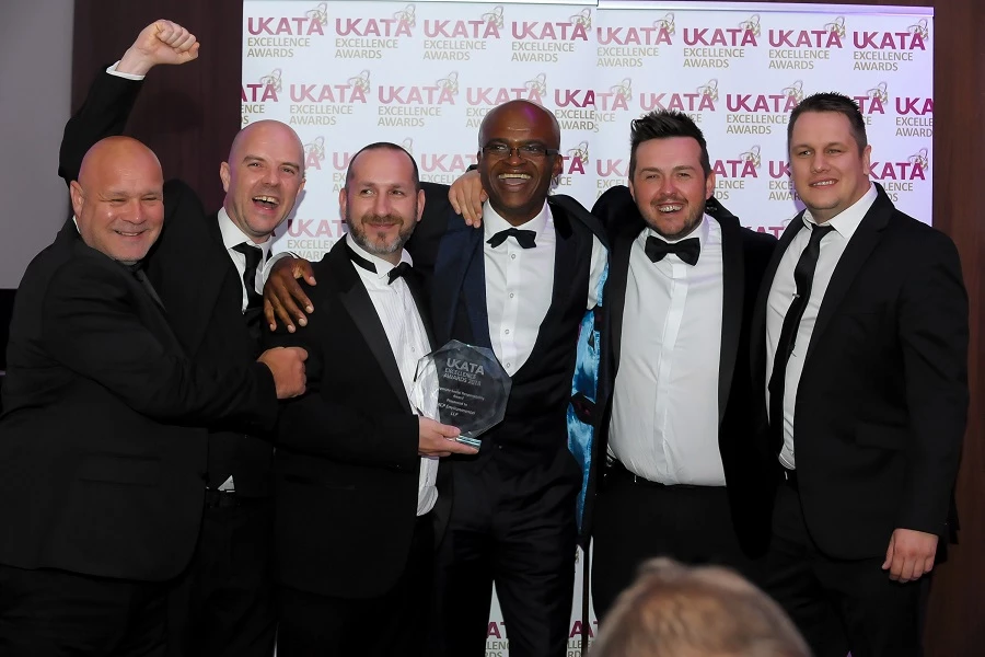The MCP Environmental team celebrate their award win with Olympic sporting legend Kriss Akabusi at the 2018 UKATA Excellence Awards