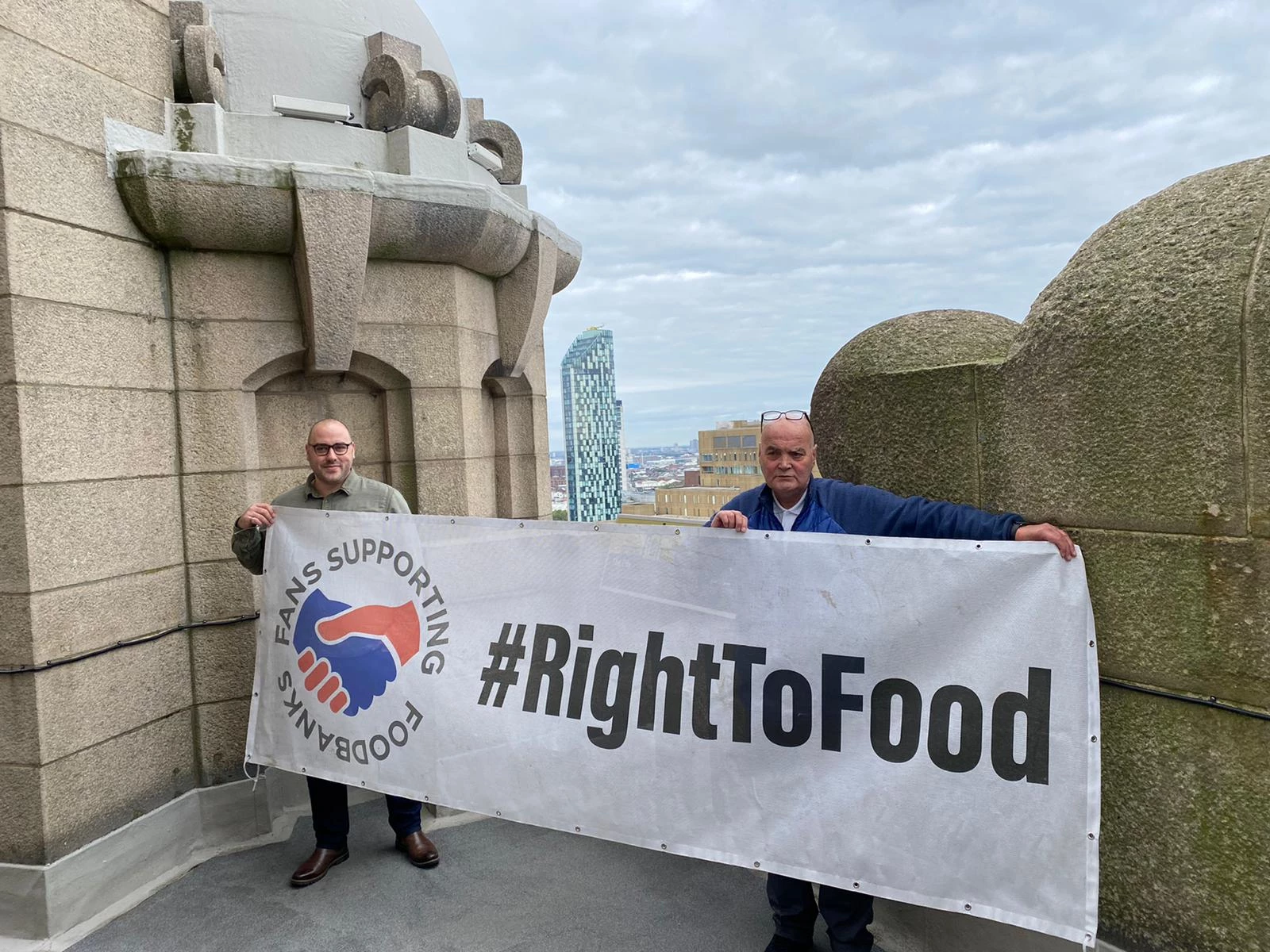 A picture of Fans Supporting Foodbanks organiser Dave Kelly (R) standing at the RLB360 attraction with Chris Devaney, who runs the activity, has been attached