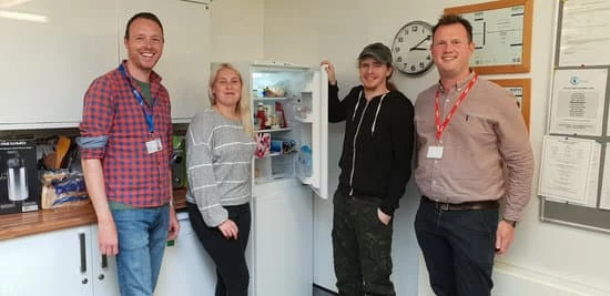 Paul Moralee (right) Karbon's community investment manager presents fridge freezer to Children North East 
