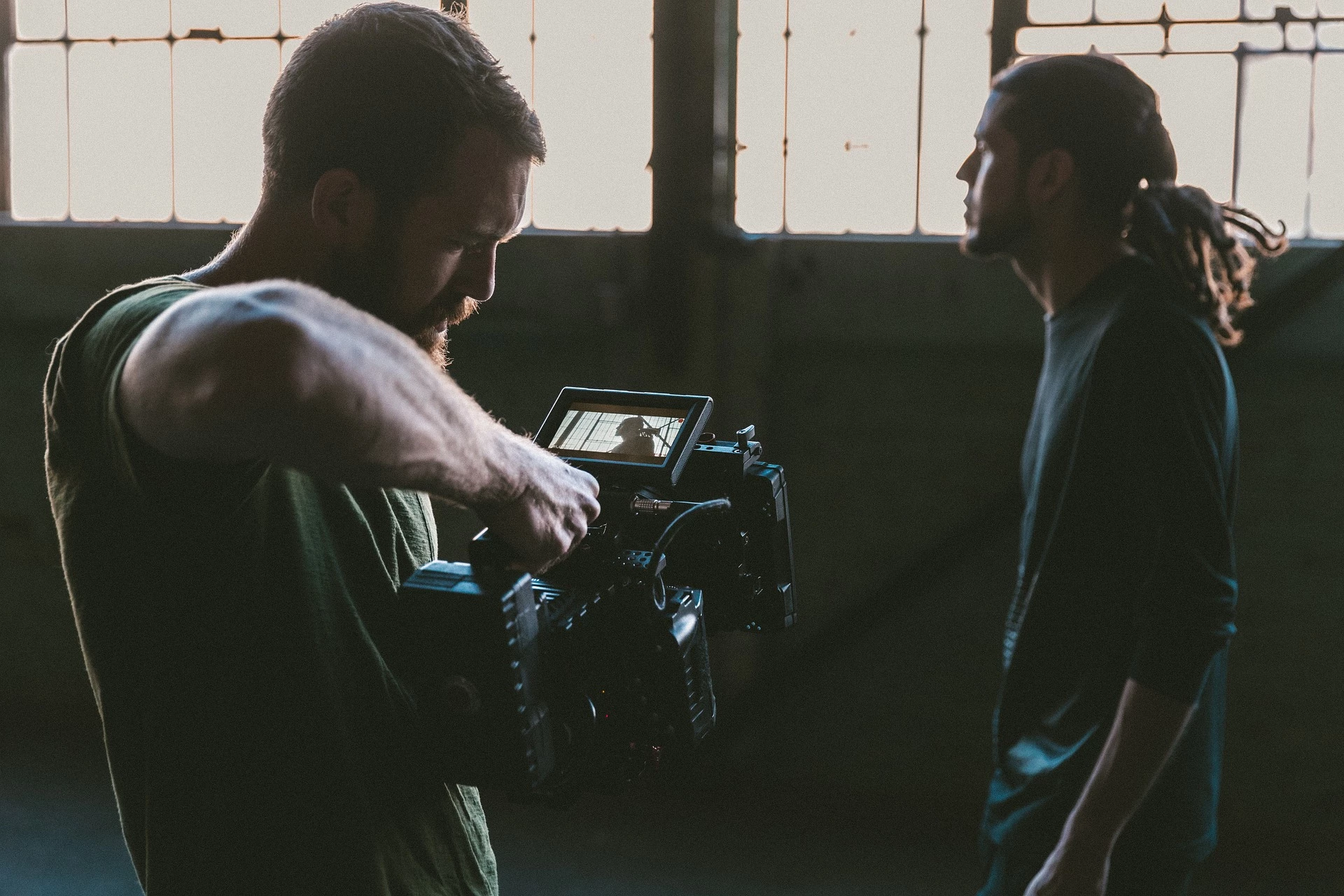 Filmmaker capturing a man standing in front of him
