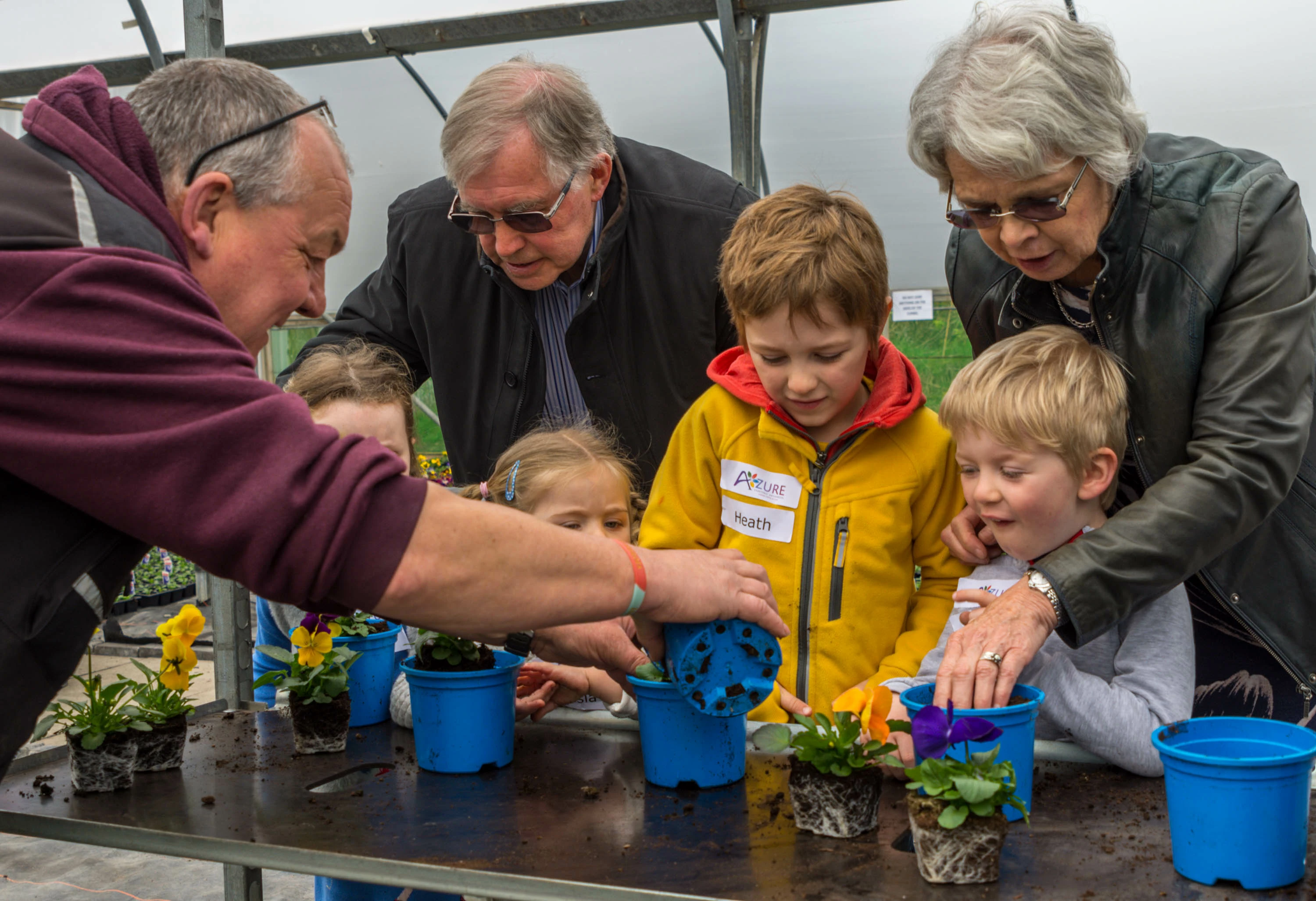 Janet & Stuart Kirkby help mini gardeners with planting pots at Azure Garden Centre