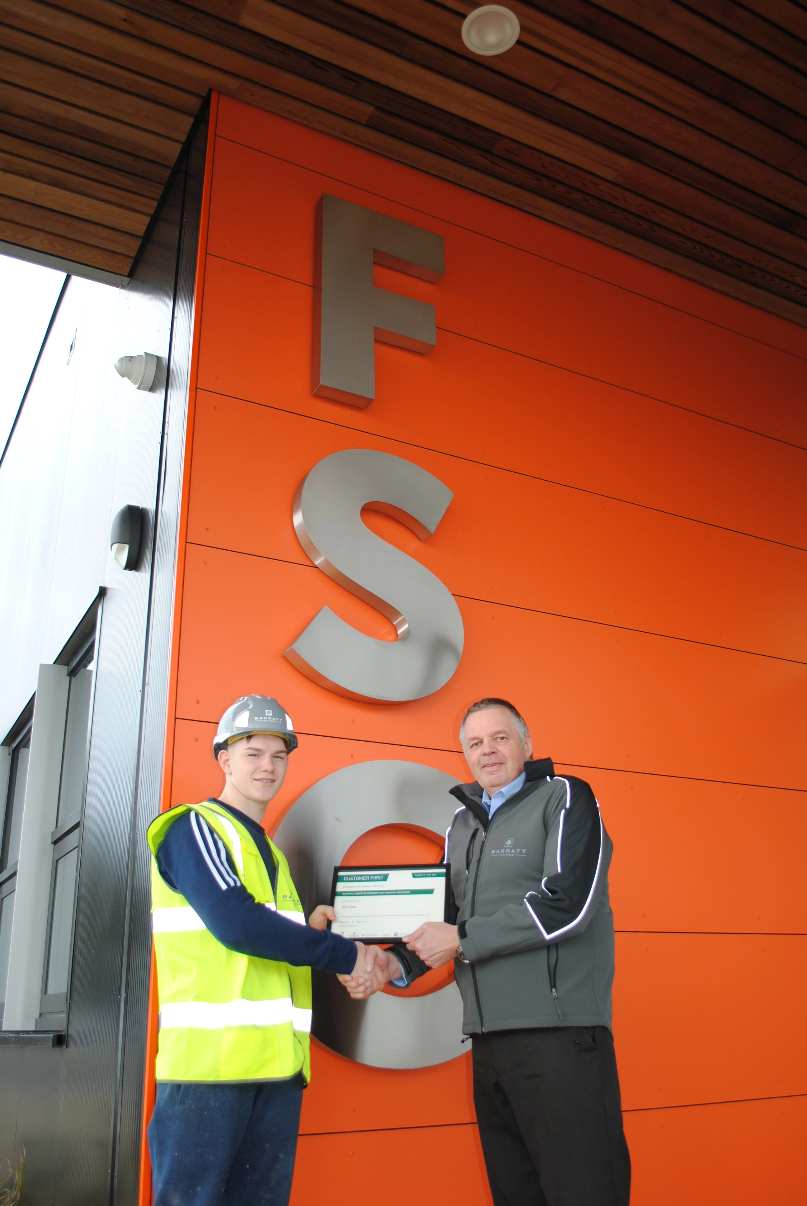 Apprentice Jack Ford receiving his award from Barratt Homes community liaison manager, Anthony Dimmick