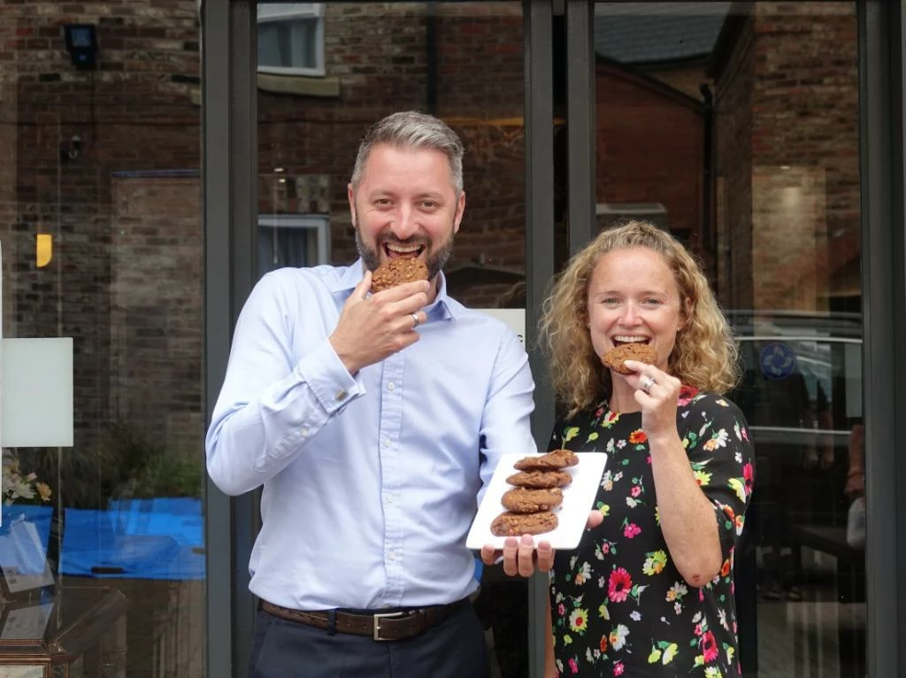 Graham Usher, General Manager of the Monkbar Hotel and Sales Manager Nikki Brannan tuck into the trademark Hilton cookies  