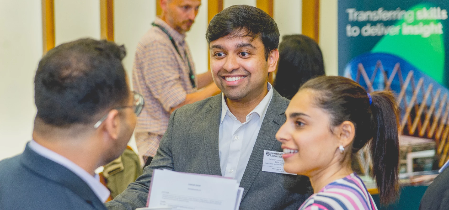 Three MBA students at a business networking event.