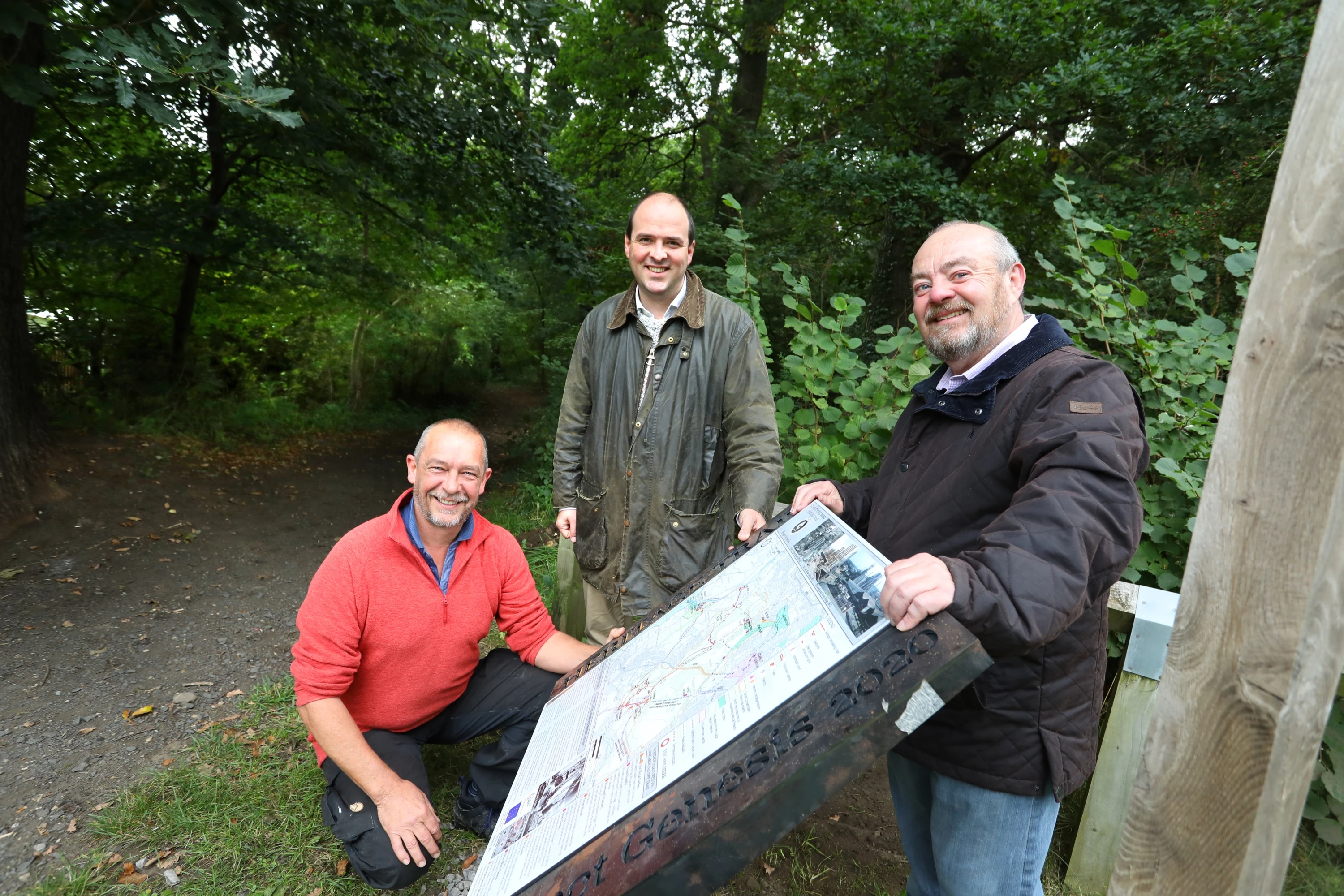 Mike Clark (left) and John O’Connor (right) of Project Genesis Trust with Richard Holden MP (centre) next to new signage on the Consett Heritage Trail.