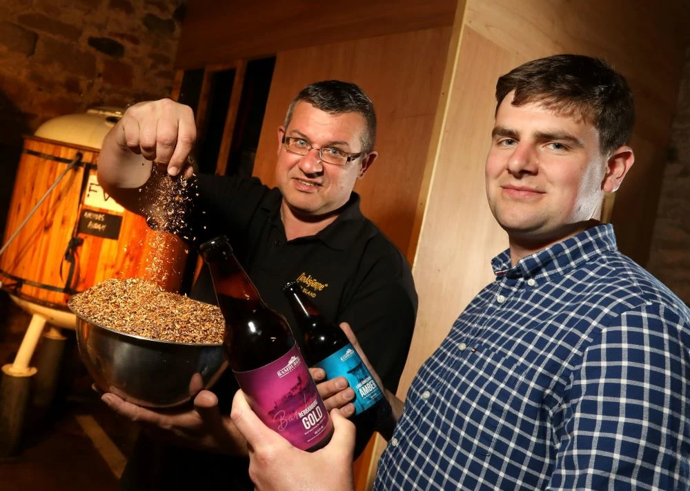 Bamburgh Castle owner William Watson-Armstrong with Alnwick Brewery's Jannick Genouw and the special anniversary beers