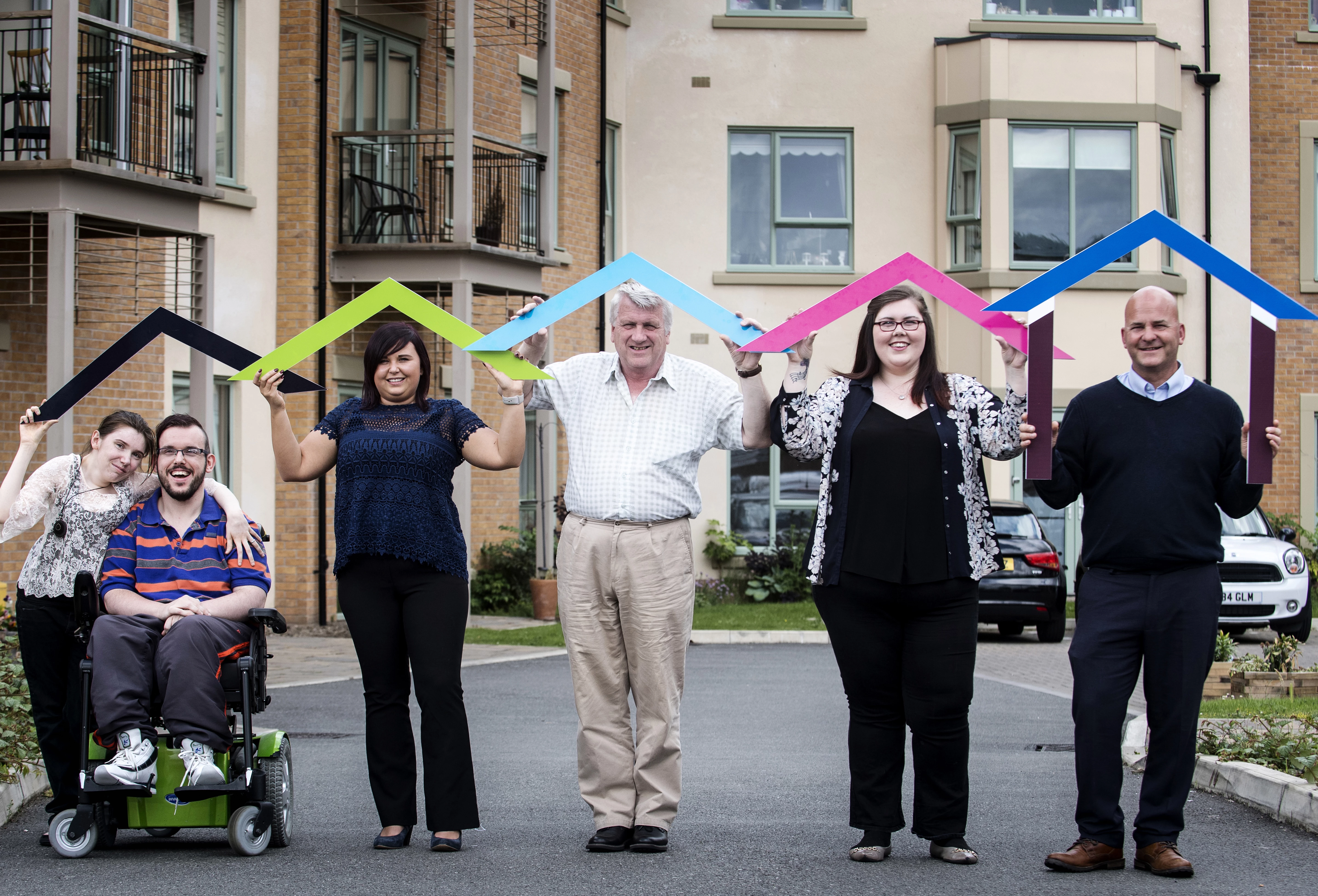 Housing Plus customers and colleagues are shown in an image from the group's annual report 