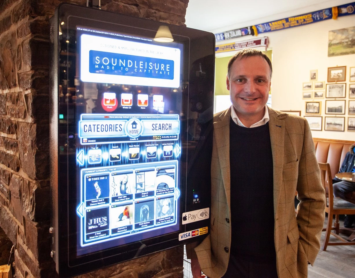 Chris Black with the first Sound Leisure contactless jukebox in The Cricketers Arms, Seacroft, Leeds
