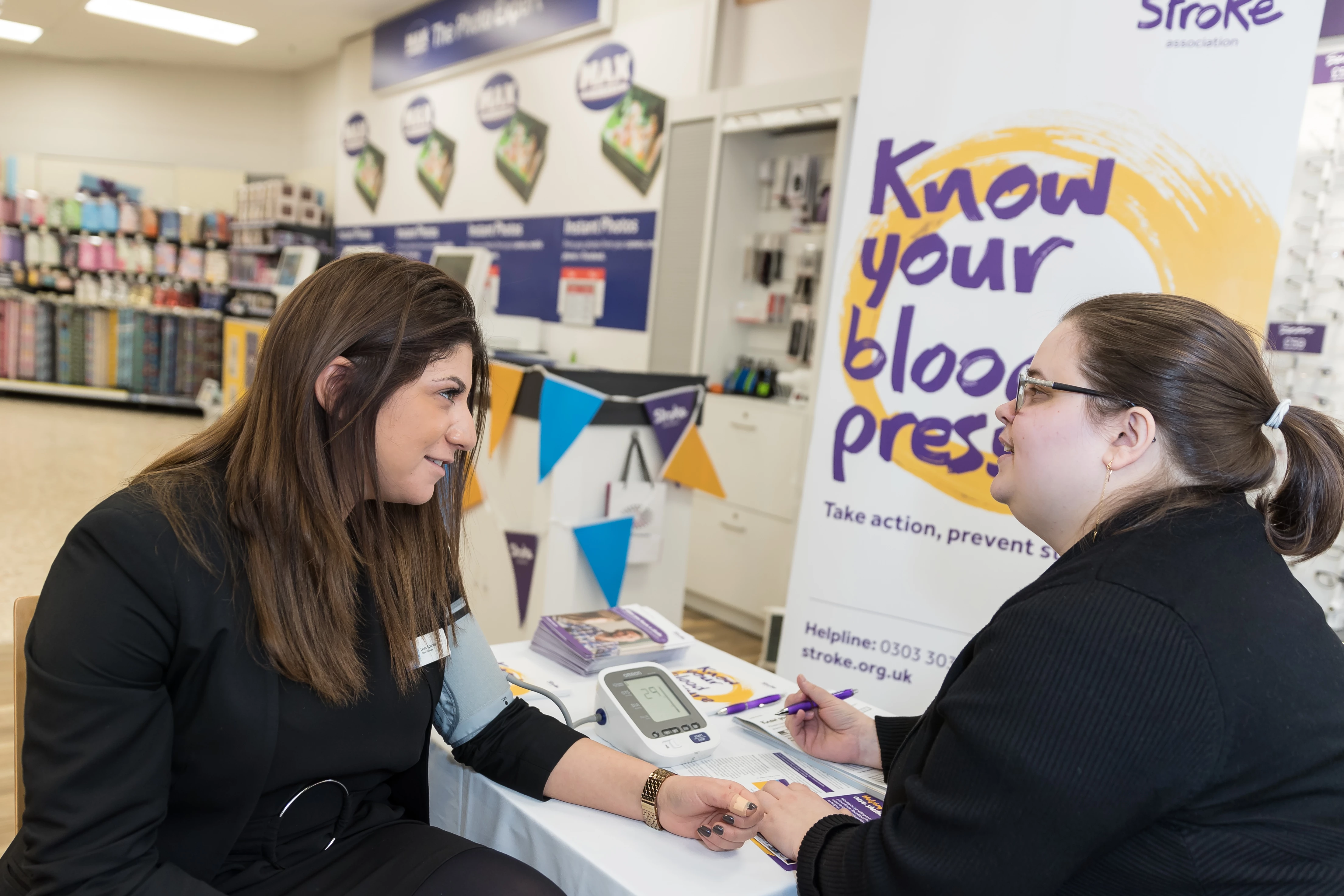 Vision Express Hatfield Store Manager Dora Spanos getting her blood pressure checked with Juliana Oliver, Stroke Association account manager. 