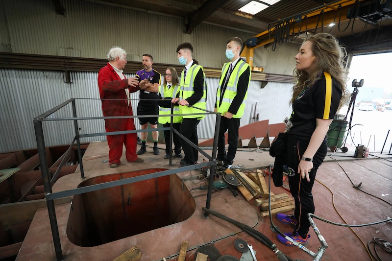 Cleveland Sitesafe steel engineer Barry Marshall shows the pupils and NPCAT Sport director Stephen Monan and St Peter’s head of year 11 Kate Jamison the work in progress