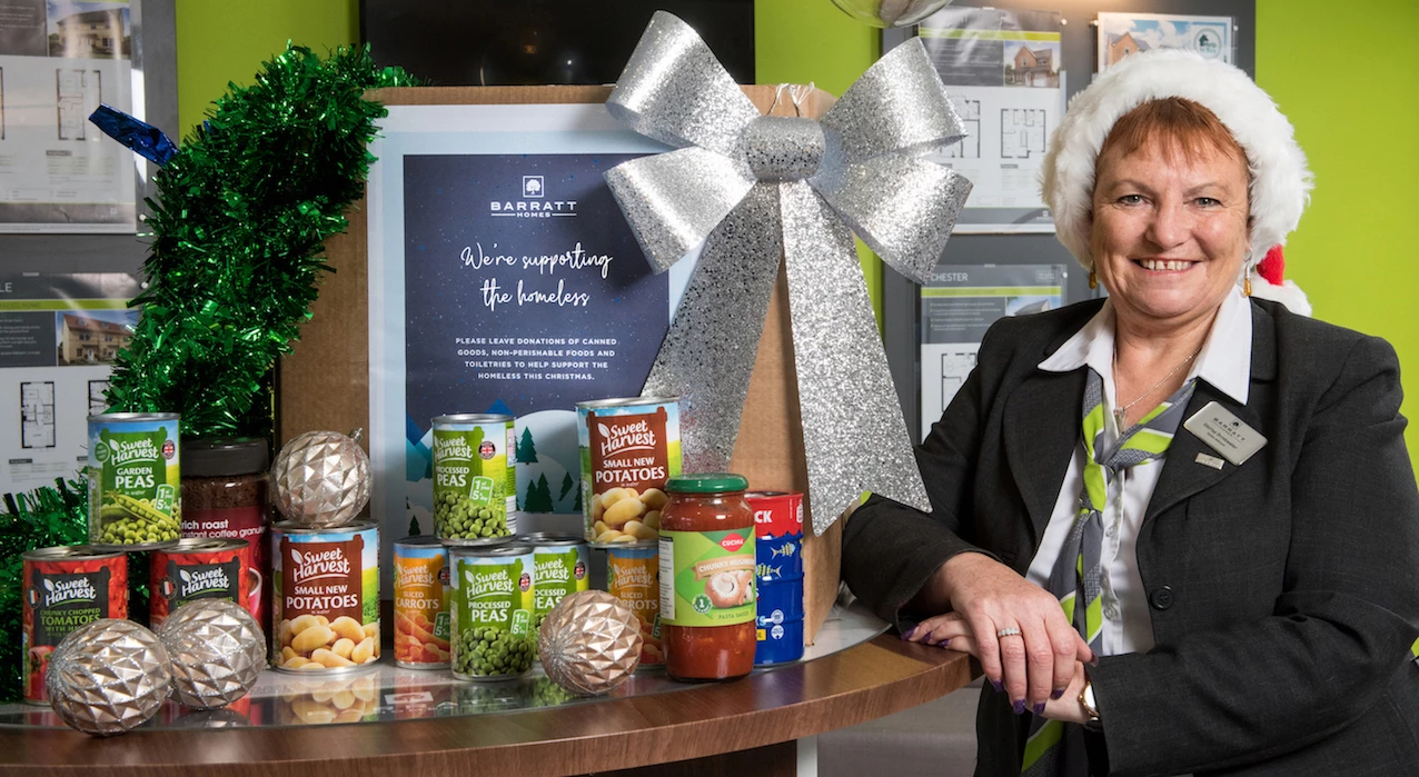 Sales Adviser, Shirley with a Christmas donation box