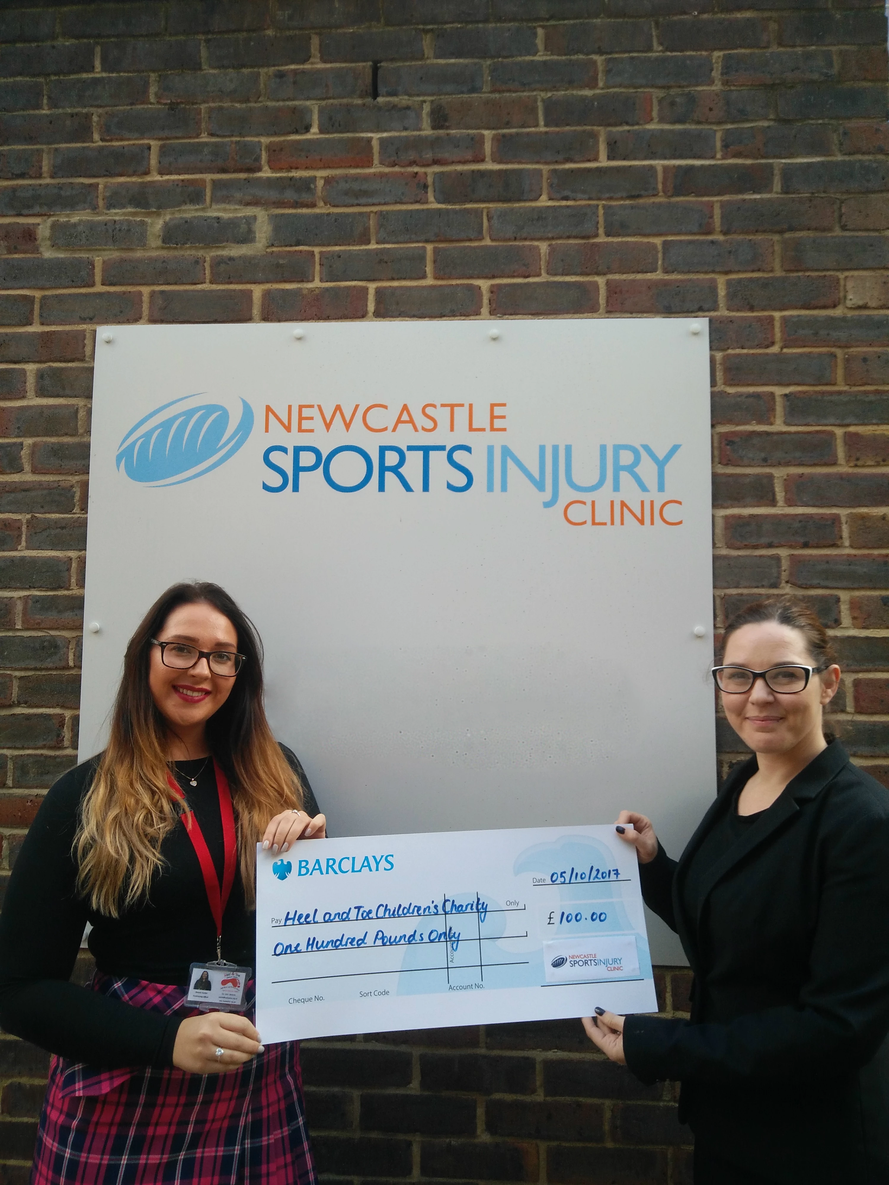 Natalie Harker, left, from Heel and Toe Children's Charity, collects the charity cheque from Emma Vinton, Newcastle Sports Injury Clinic