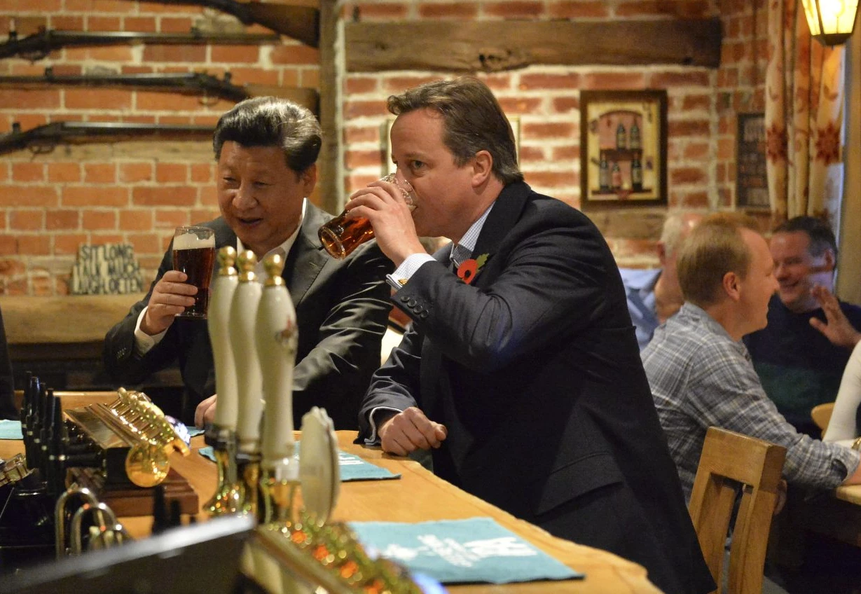David Cameron sinking a pint with Xi Jinping.